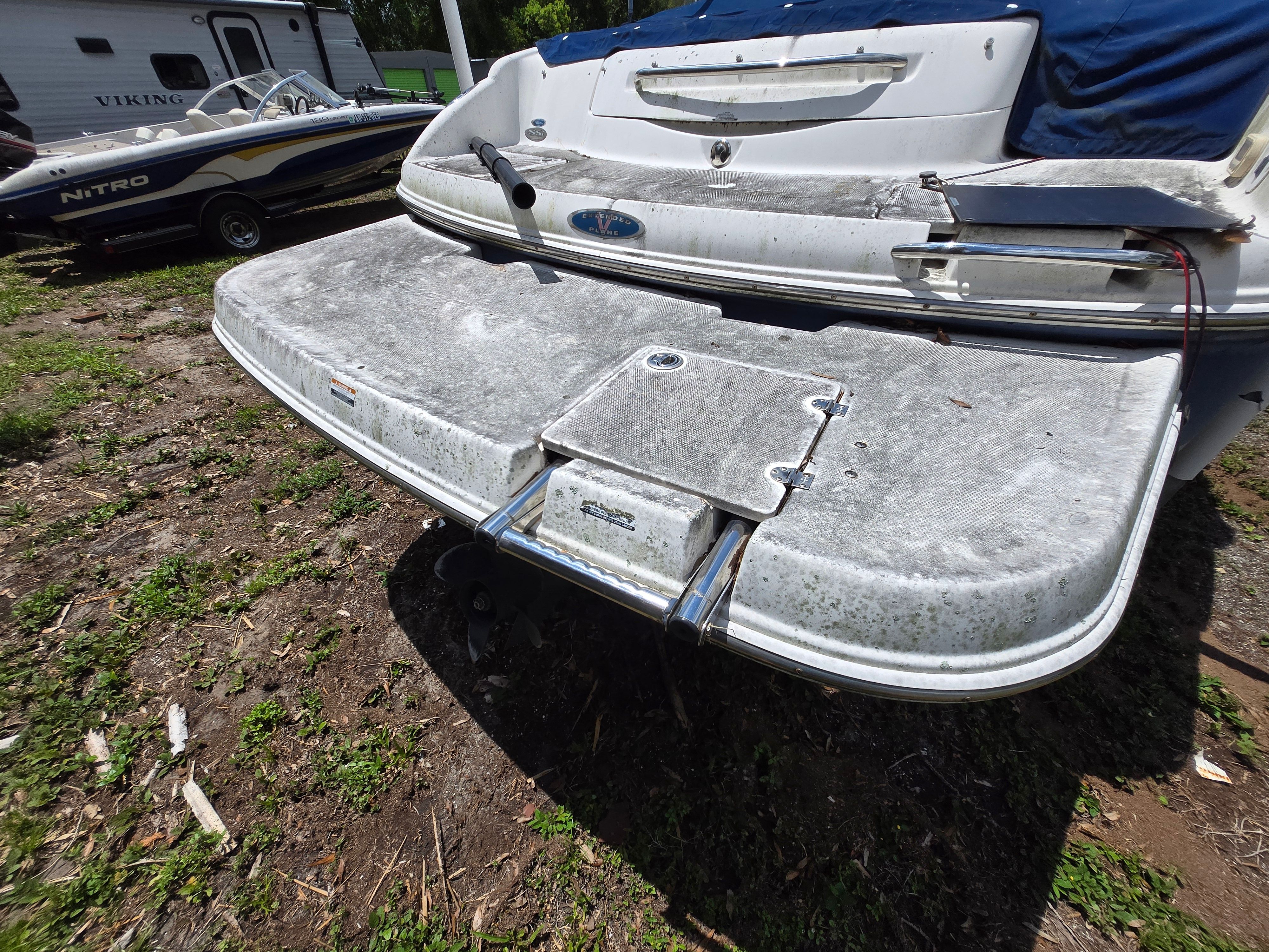 The image shows the rear of a 2006 Chaparral 220 SSi boat with a swim platform.