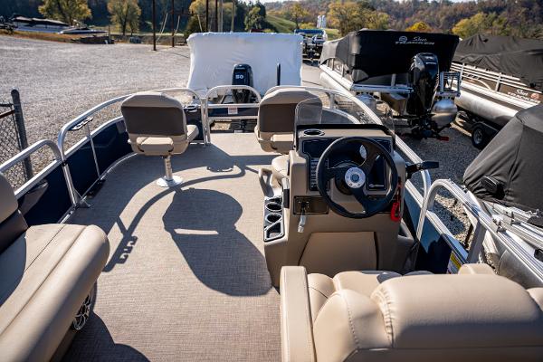 2025 Sun Tracker Bass Buggy 16 DLX pontoon boat interior with steering console and seating.