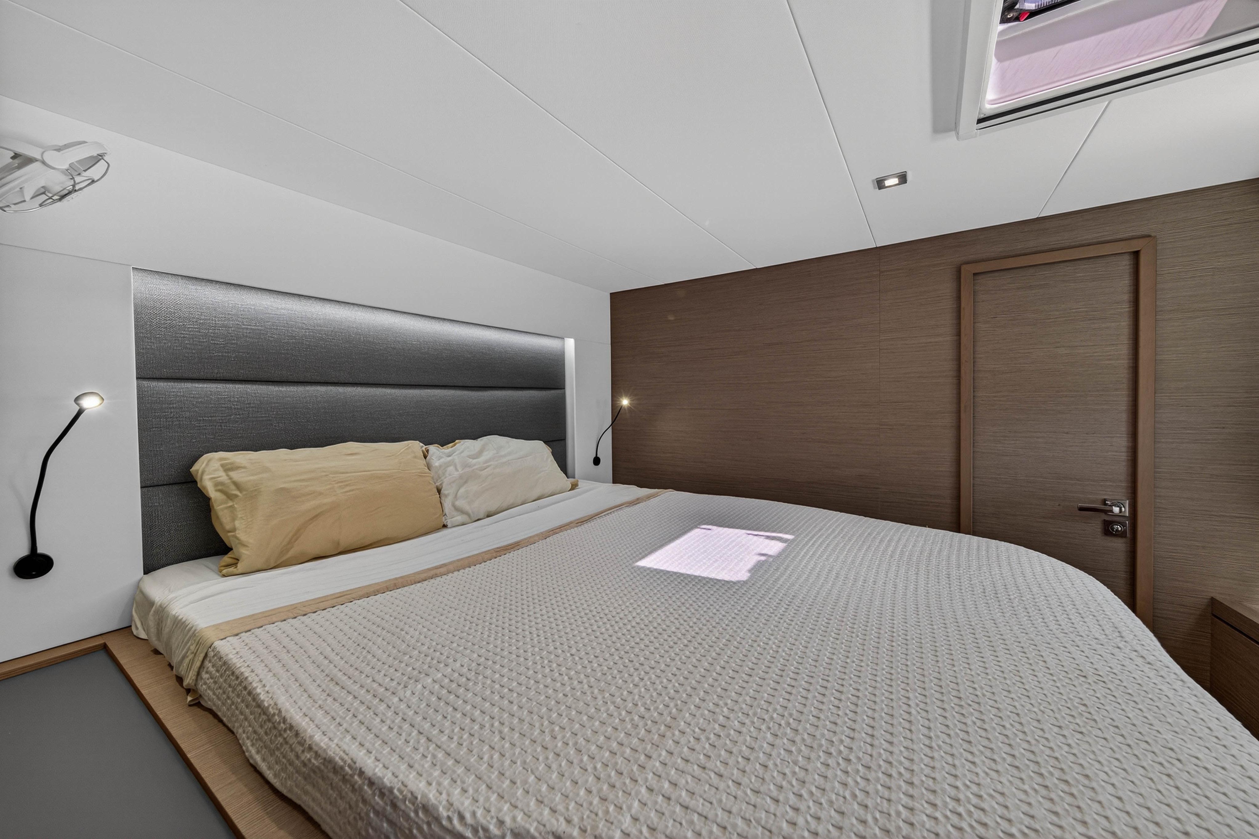 Luxurious bedroom interior of 2022 Fountaine Pajot Tanna 47 yacht, featuring modern design.