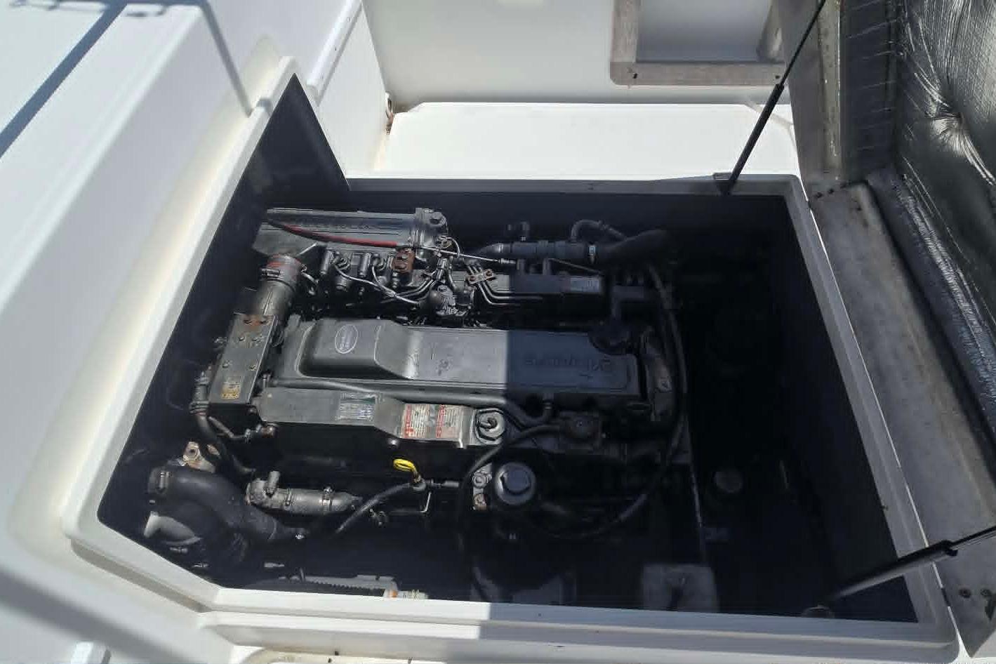 Engine compartment of a 2003 True World Marine 286 boat, showcasing detailed mechanical components.