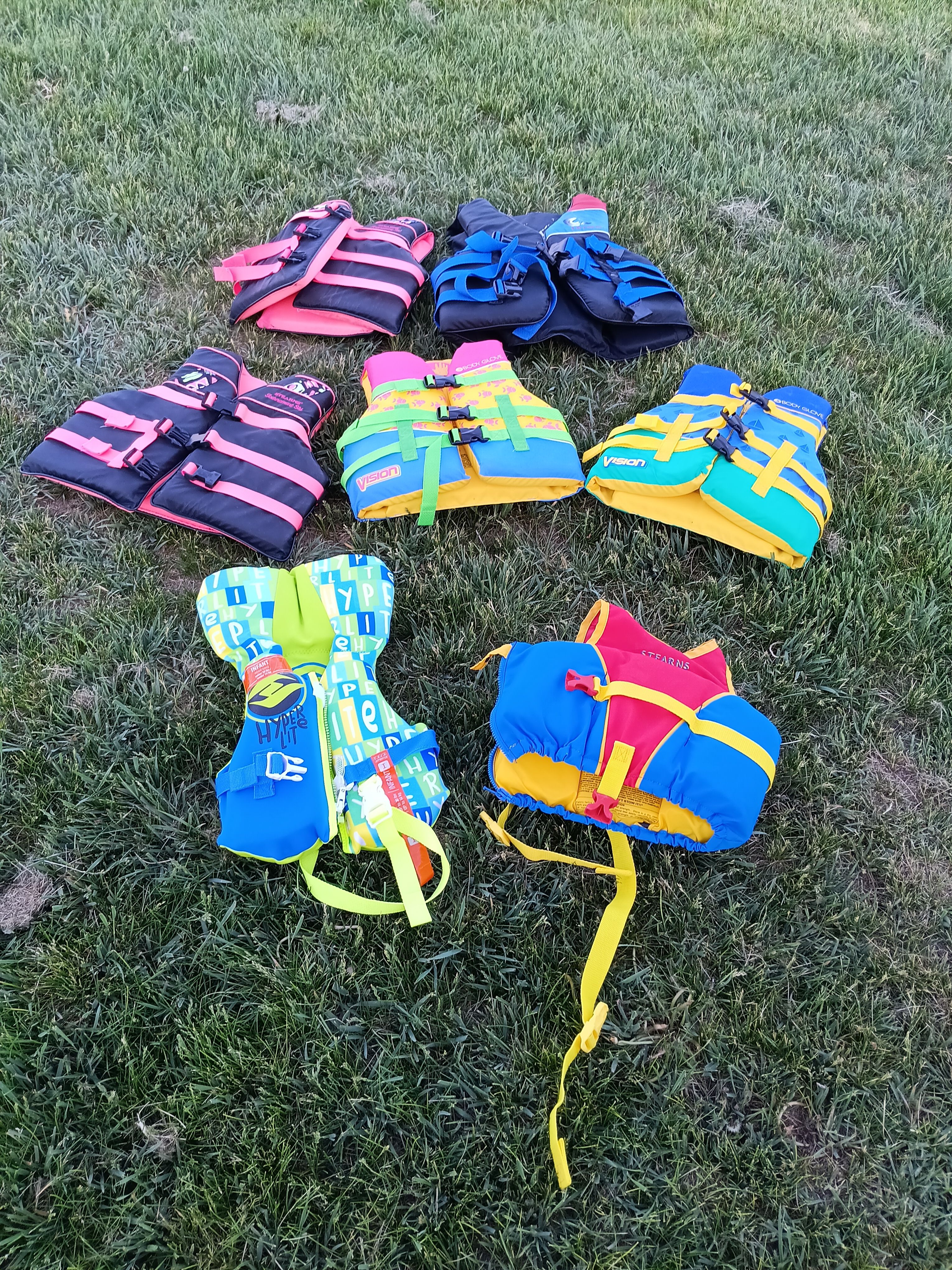 Colorful life jackets on grass, matching Malibu Skier 1991.