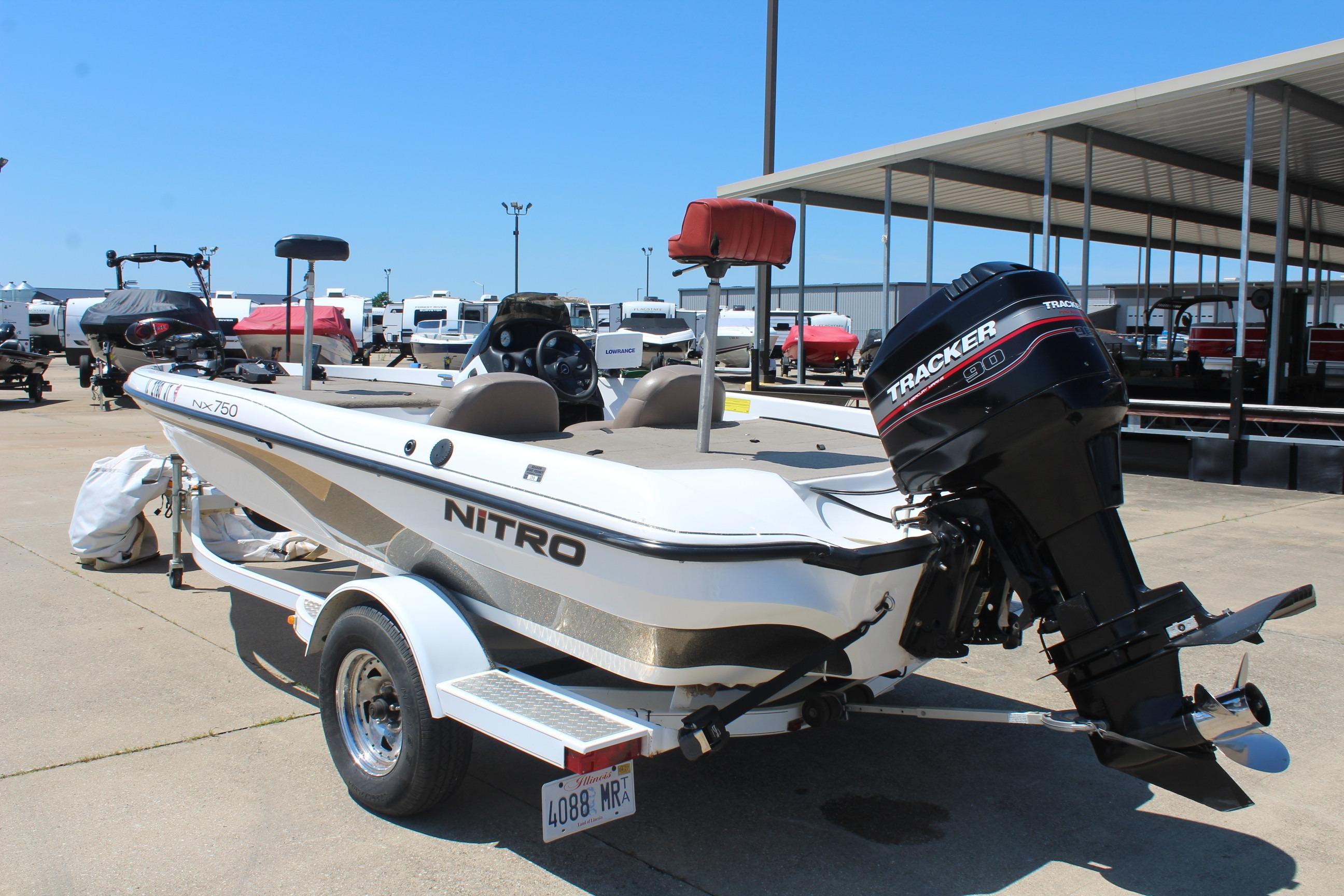 2003 Nitro NX 750 SC boat with Tracker engine on trailer in marina.