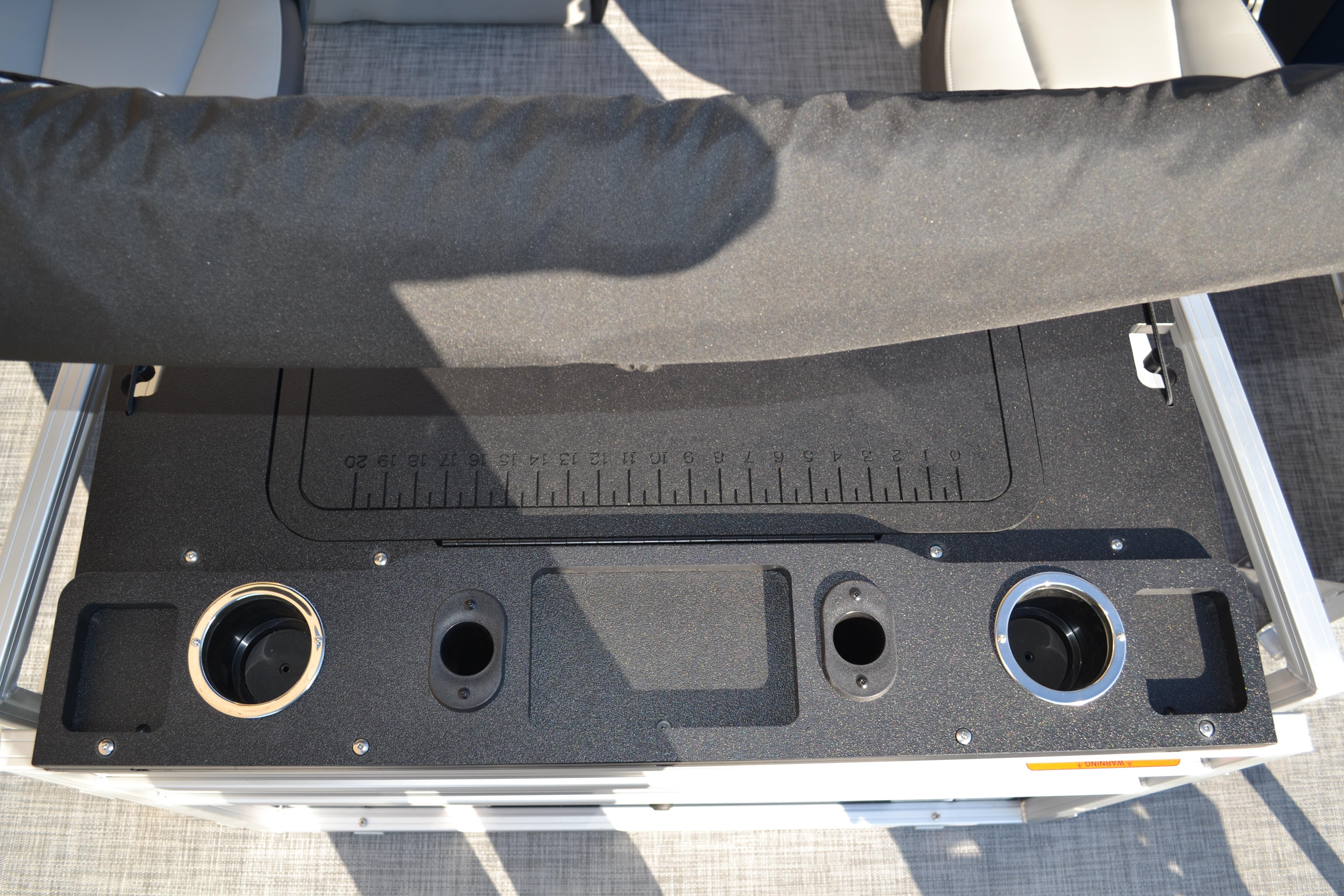 2026 Sun Tracker SportFish 22 XP3 boat console with cup holders and measurement markings.
