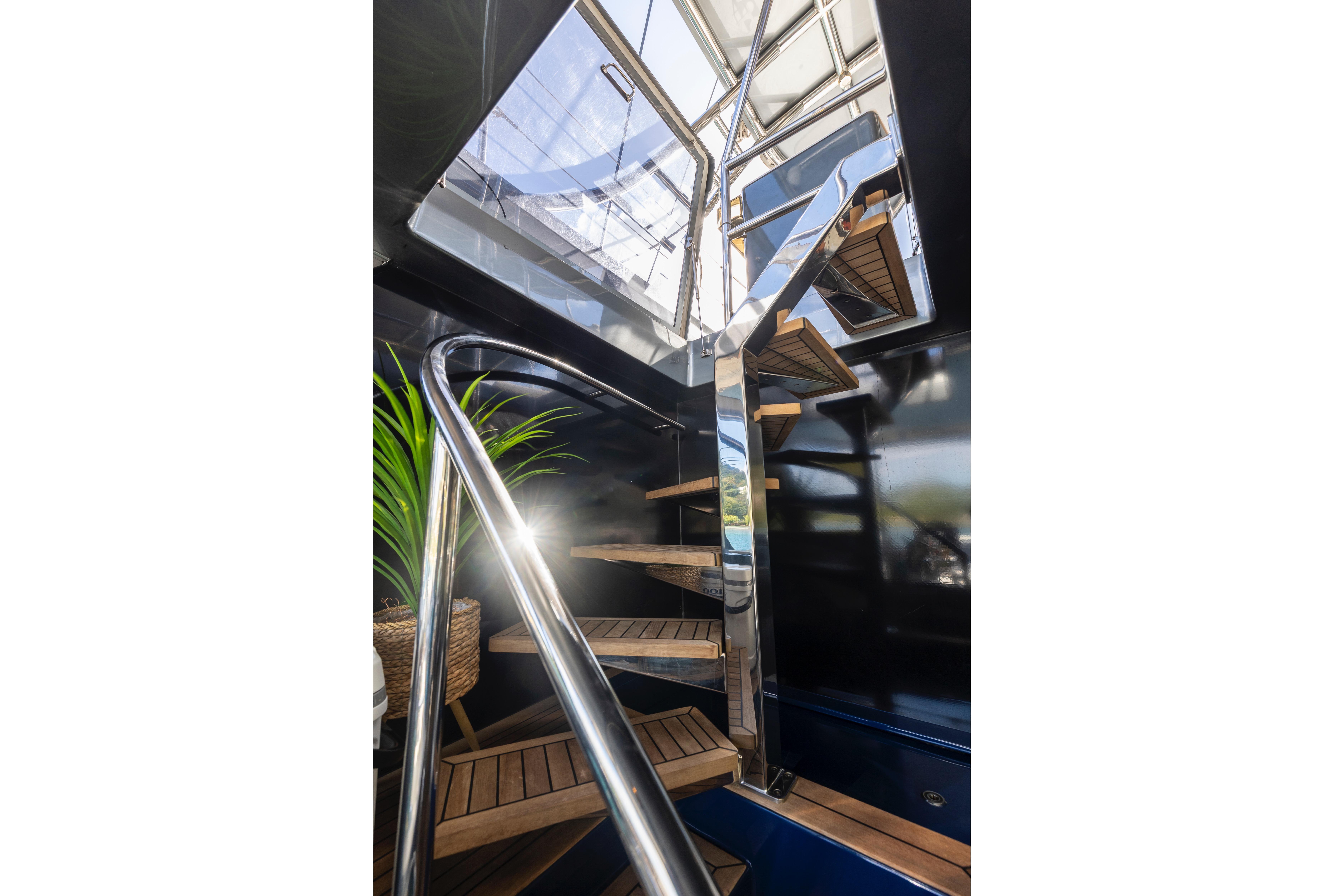 Modern staircase on 2020 Sunreef Sail 60 yacht with sleek design and natural light.