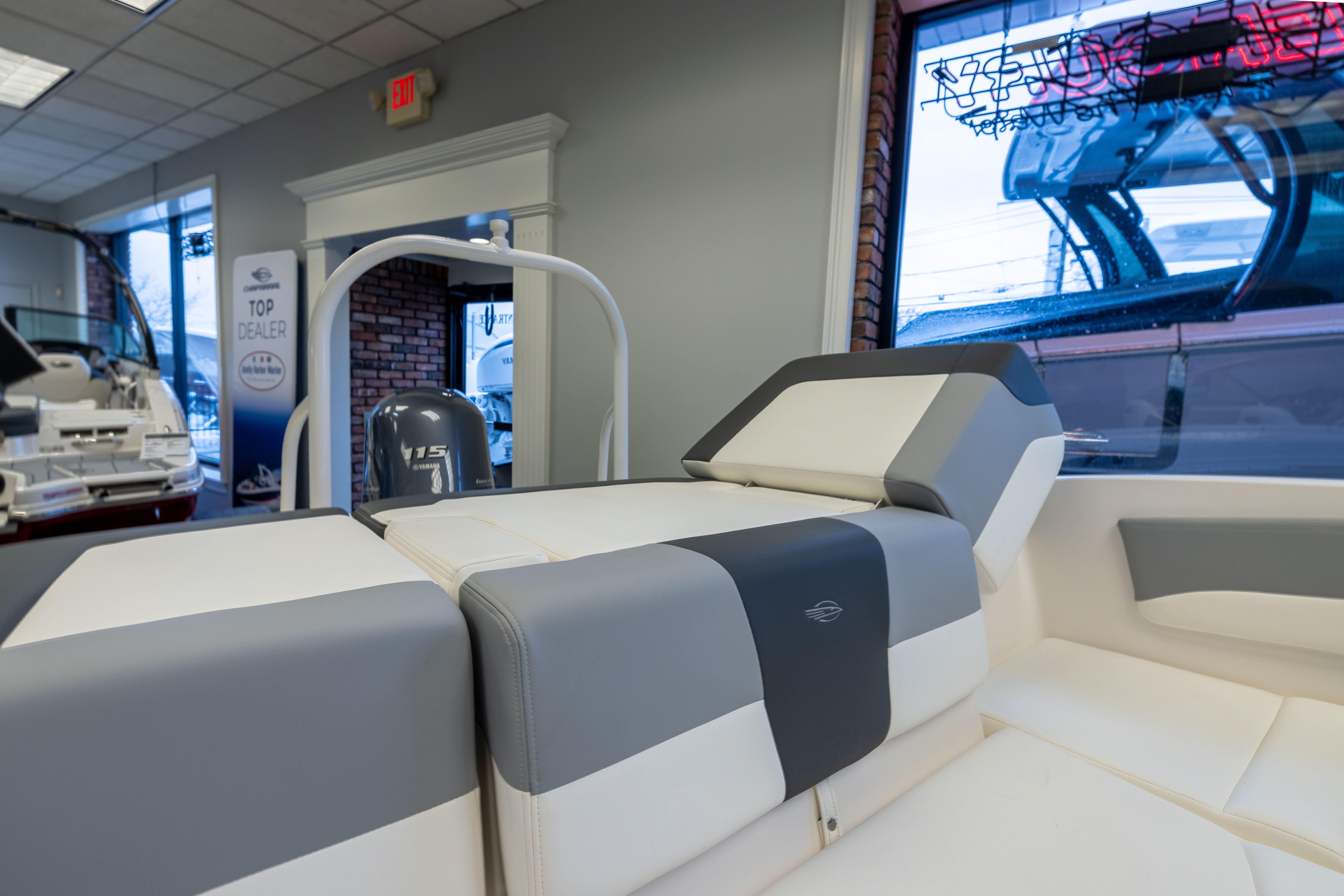 2024 Chaparral 19 SSi OB boat interior with stylish seating in a showroom.