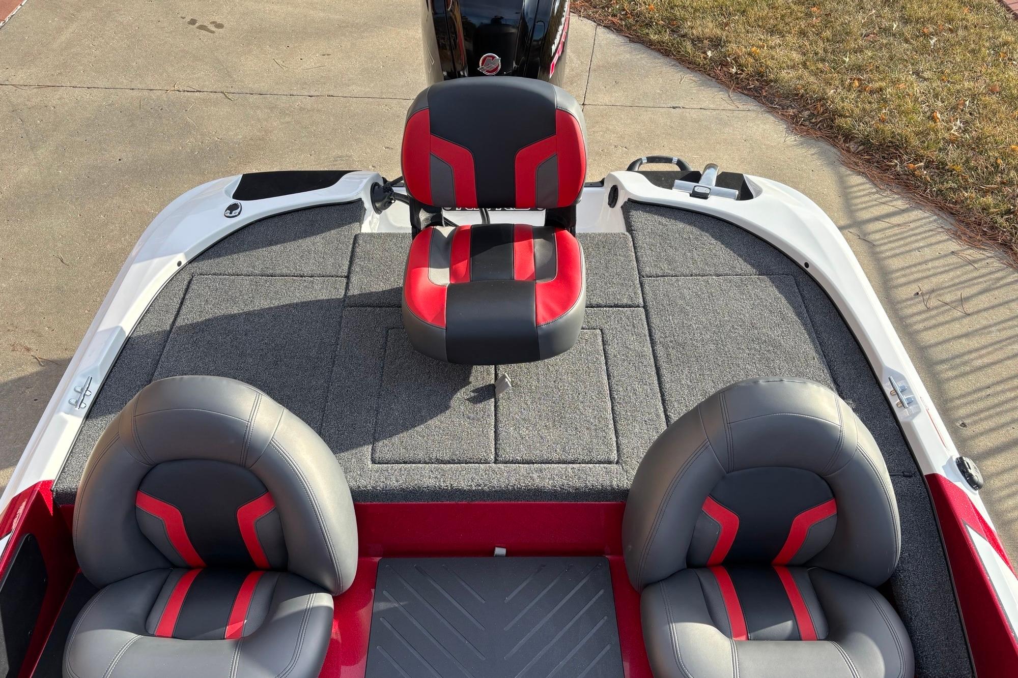 2026 Nitro Z17 boat interior with red and gray seating, carpeted deck.