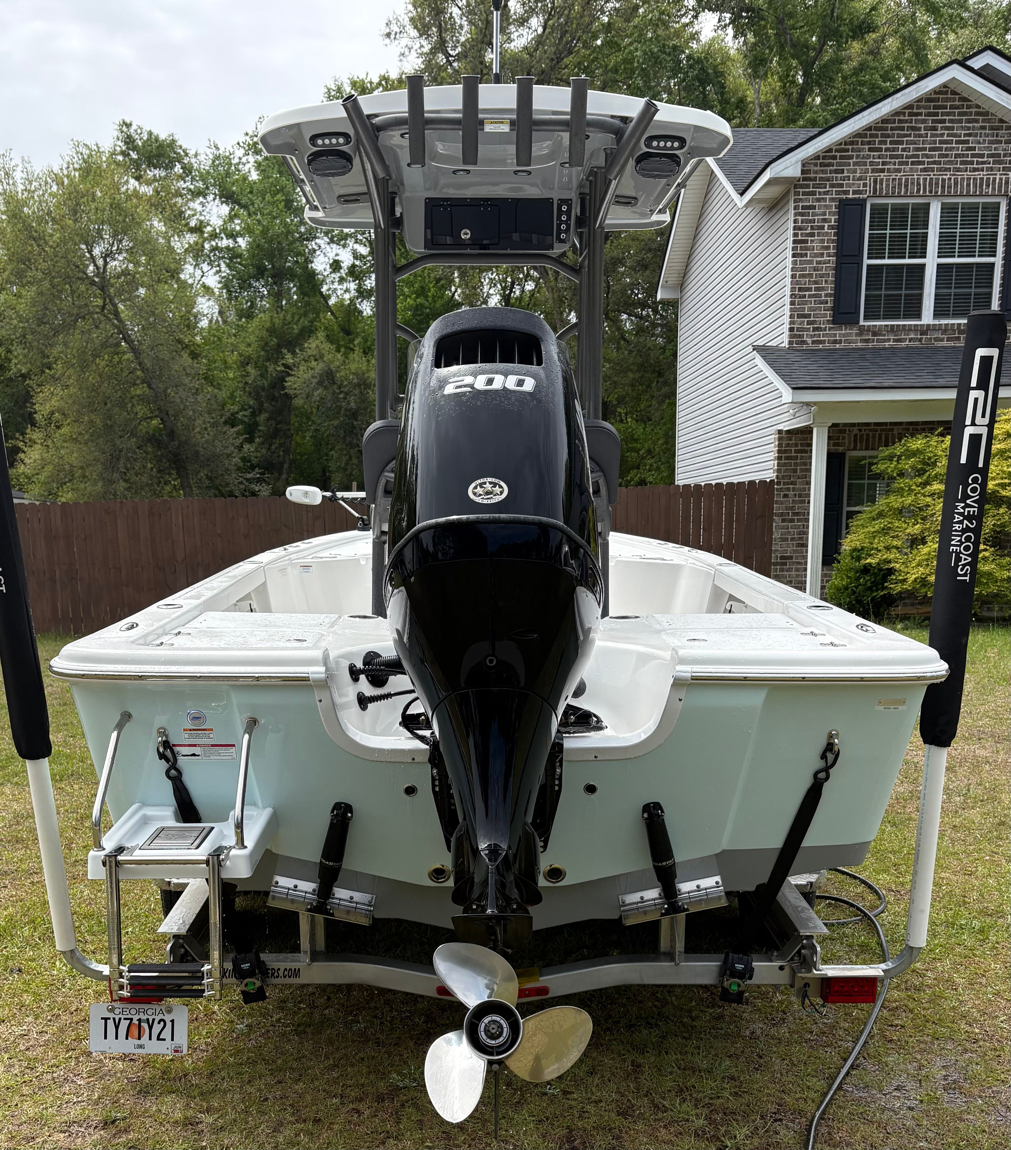 Rear view of a 2025 Sea Pro 230 Bay boat with outboard motor.