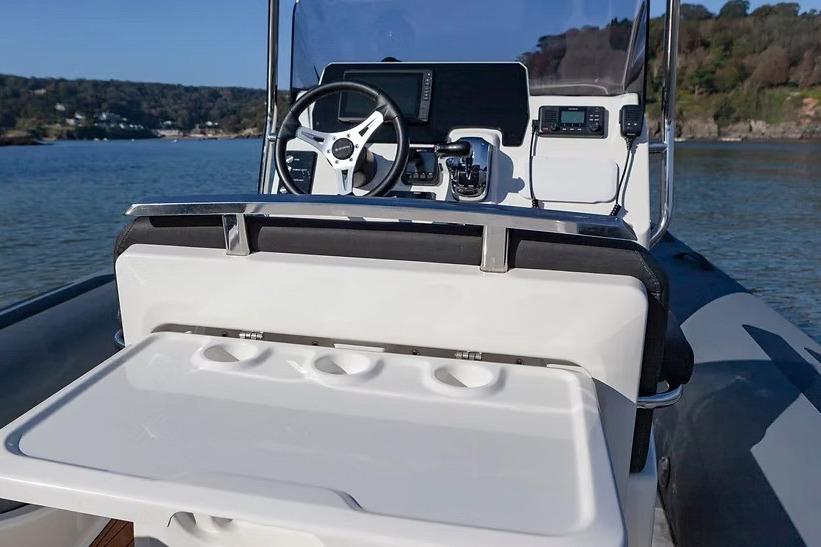 Manufacturer Provided Image: 2026 Brig Eagle 6.7 boat cockpit with steering wheel and control panel on water.