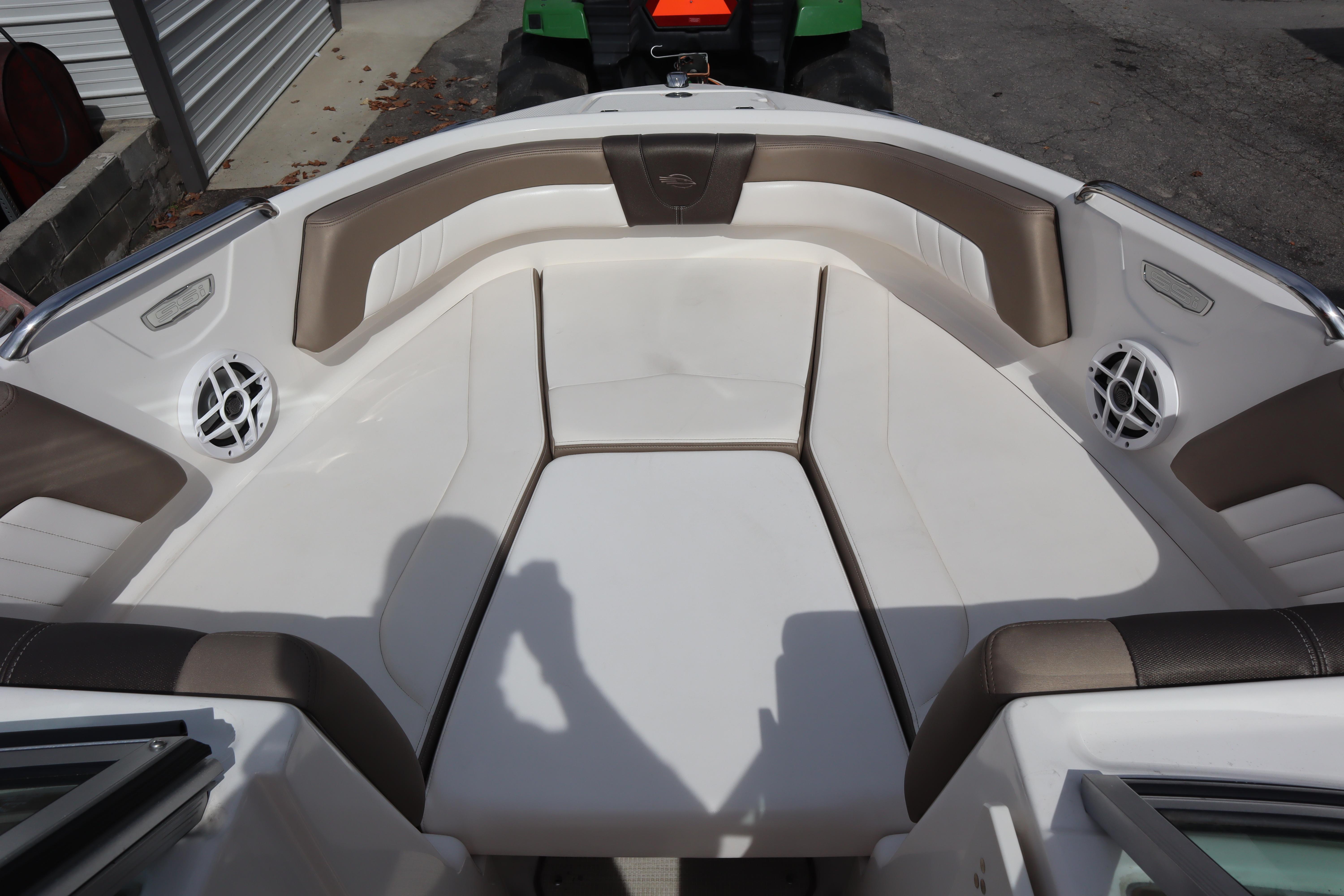 2021 Chaparral 21 SSi boat interior with cushioned seating and built-in speakers.