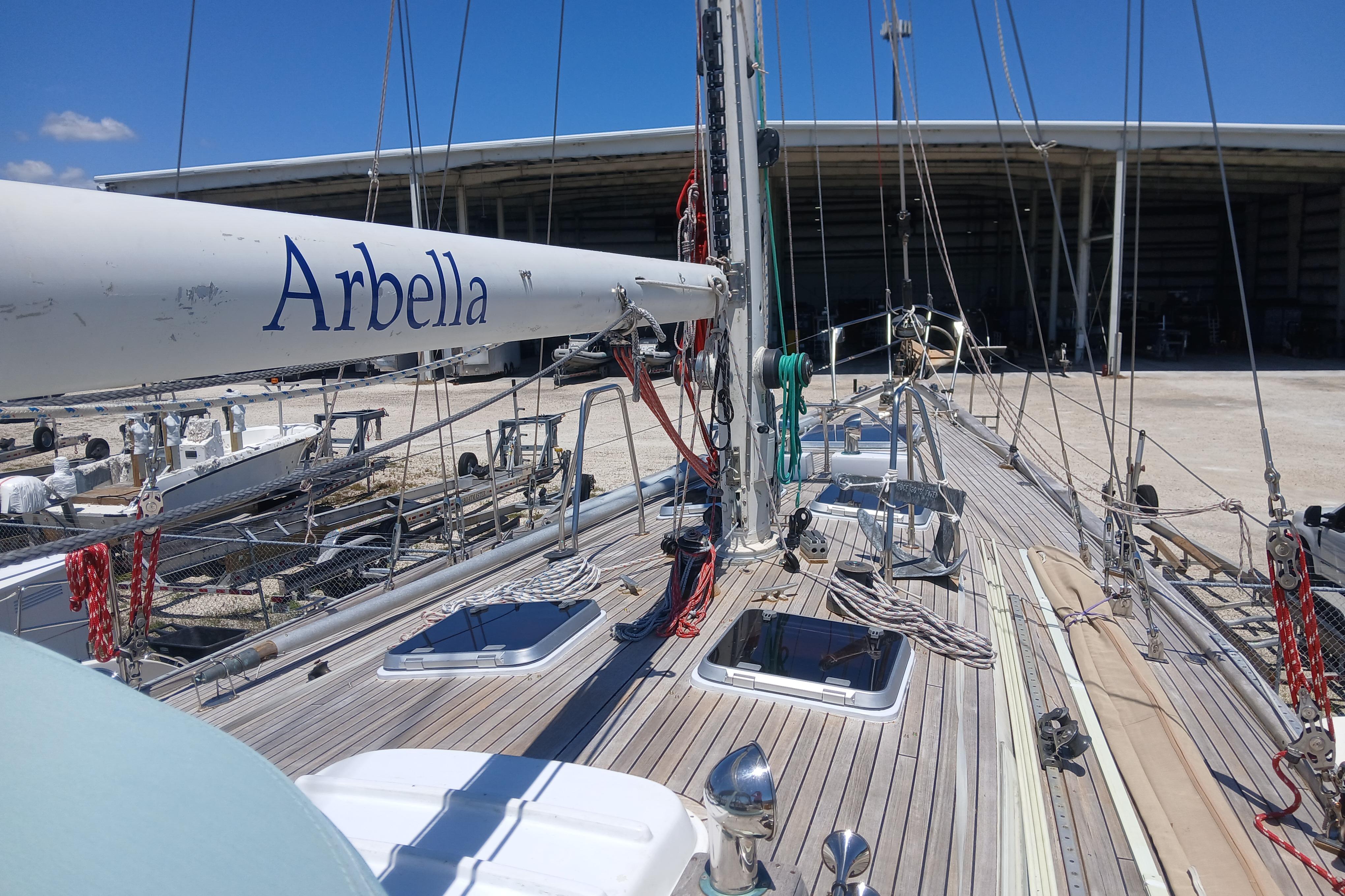 Sailboat deck view of 1981 Kaufman Skye 51, named "Arbella," in a marina setting.