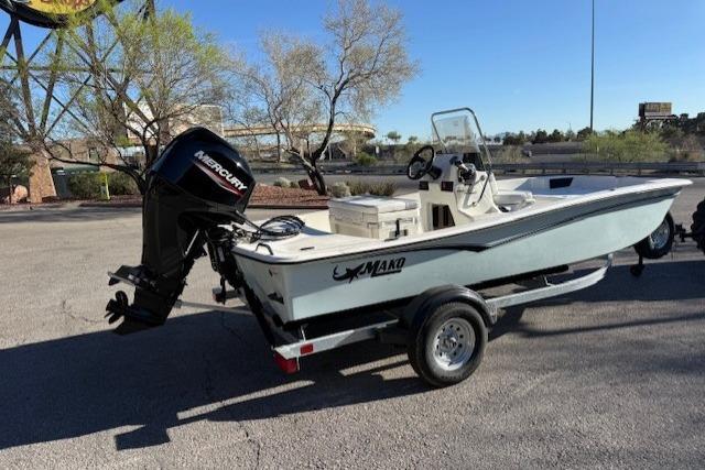 2026 Mako Pro Skiff 15 CC boat on trailer with Mercury outboard motor.