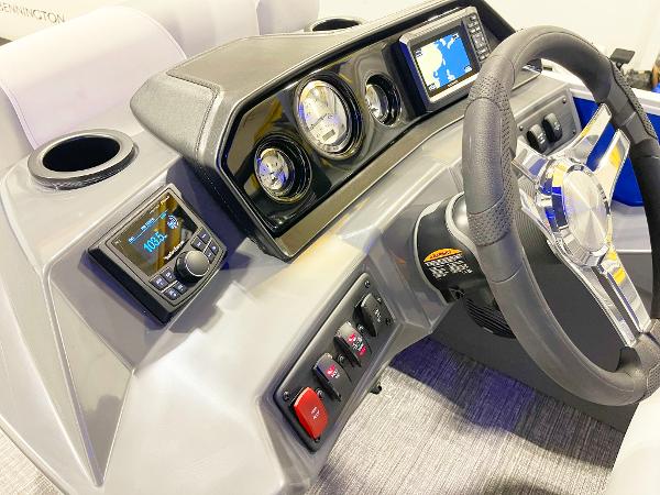 2025 Bennington 20S boat dashboard with steering wheel, gauges, and navigation system.