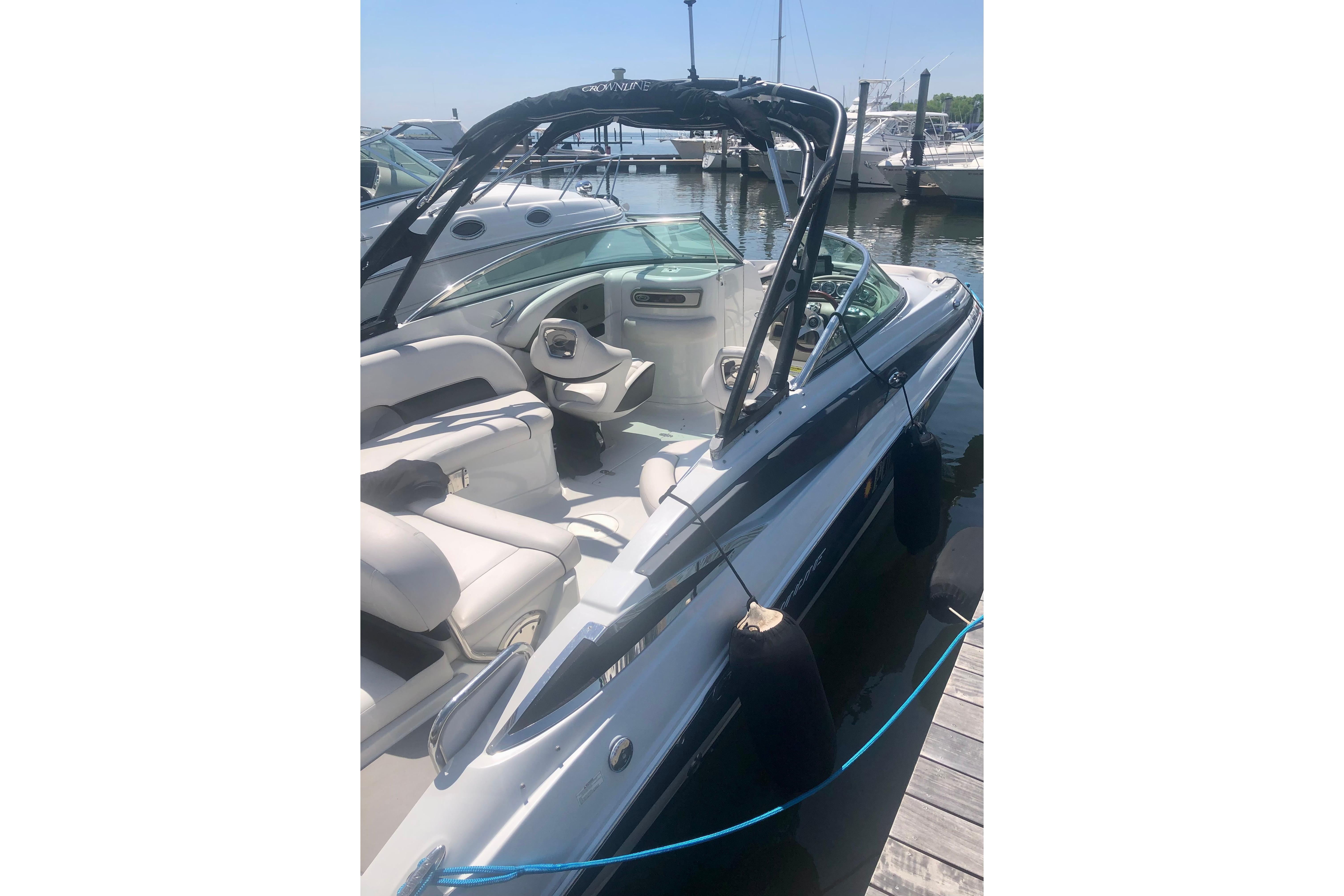 2013 Crownline Eclipse E4 boat docked, featuring sleek design and spacious seating.