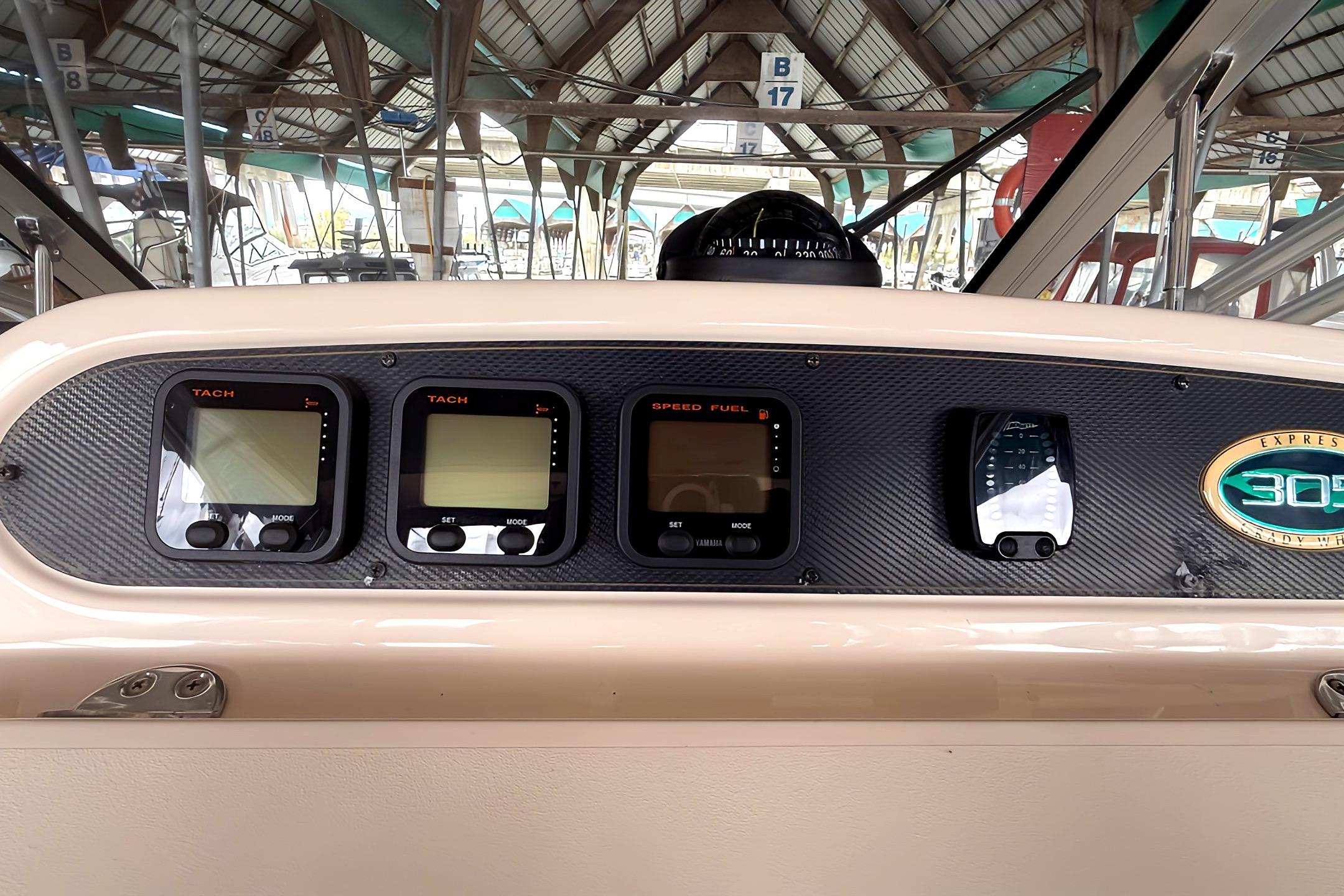 Dashboard of 2007 Grady-White Express 305 boat with tachometers and speed fuel gauges.