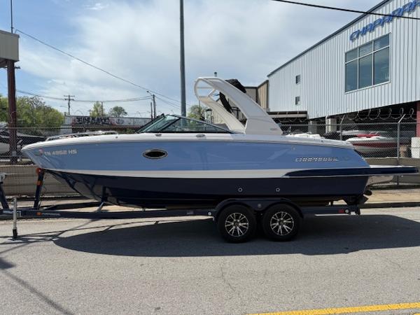 2023 Chaparral 267 SSX boat on trailer, parked outdoors near a building.