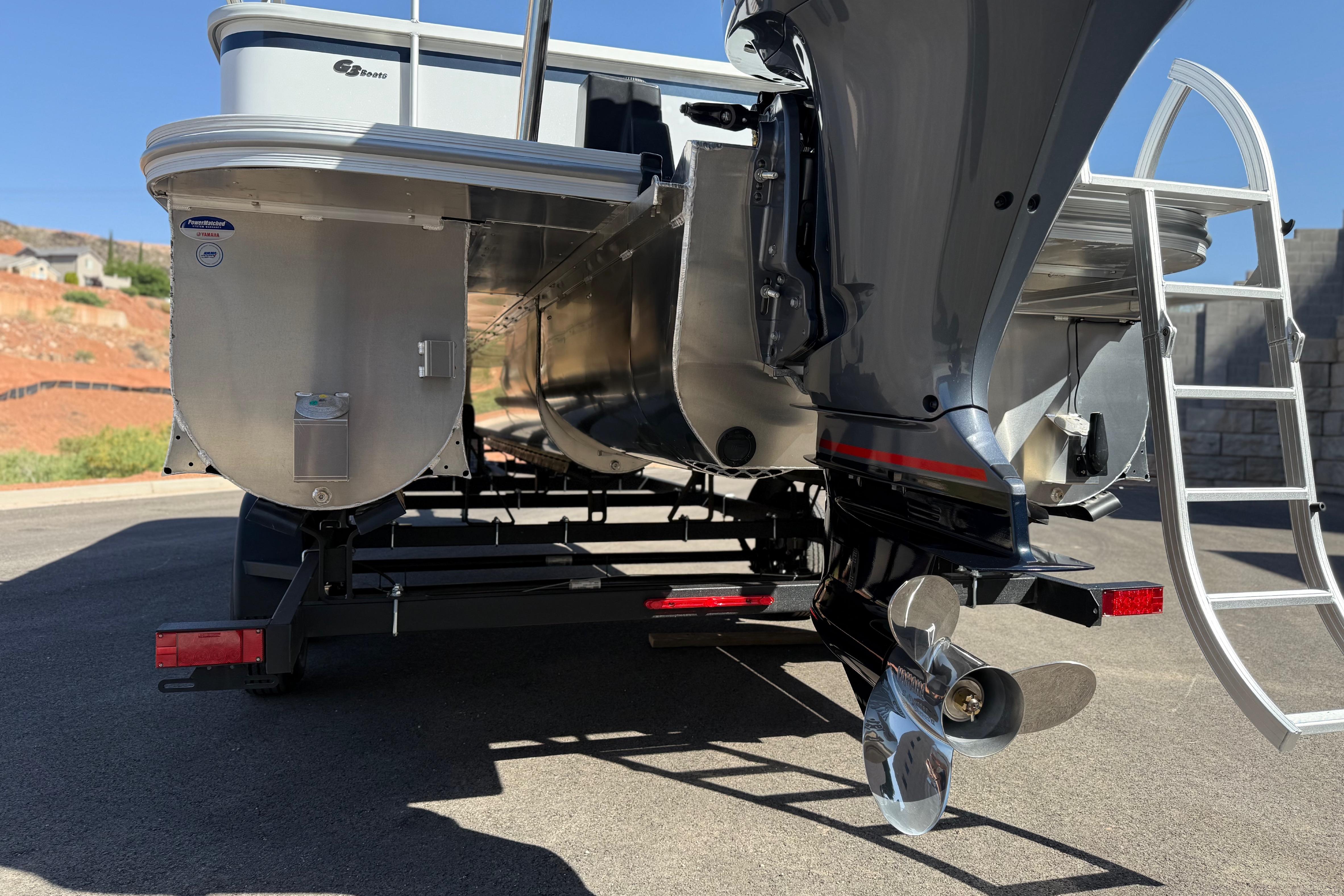 2026 SunCatcher Select 322SL pontoon boat rear view with motor and ladder.