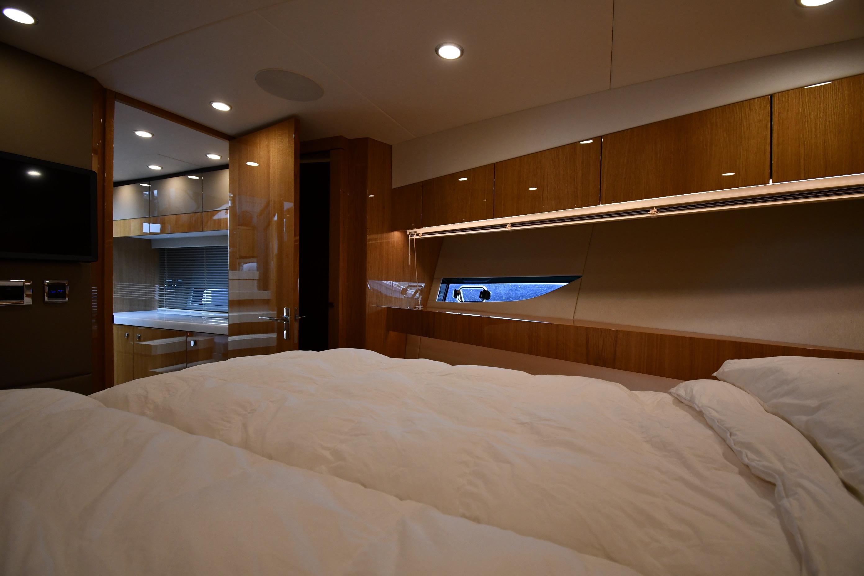 Luxurious interior of 2024 Fairline G50 Targa yacht with cozy bedroom and modern amenities.
