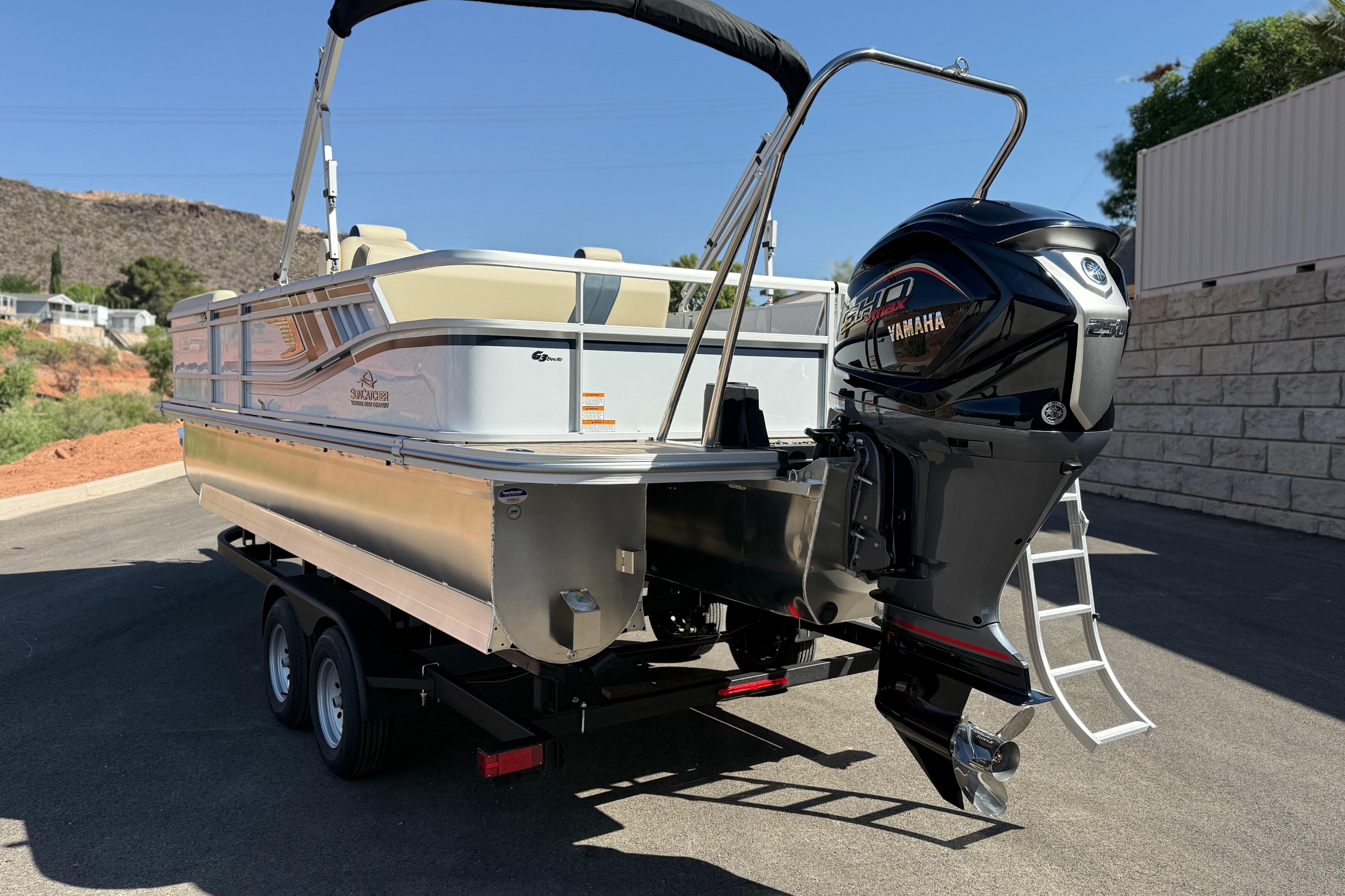 2026 SunCatcher Select 322SL pontoon boat with Yamaha outboard motor on trailer.