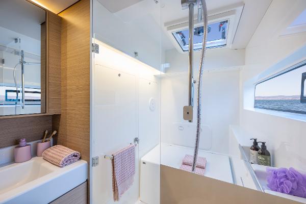 Modern bathroom in 2025 Lagoon 38 yacht with sleek design and natural light.