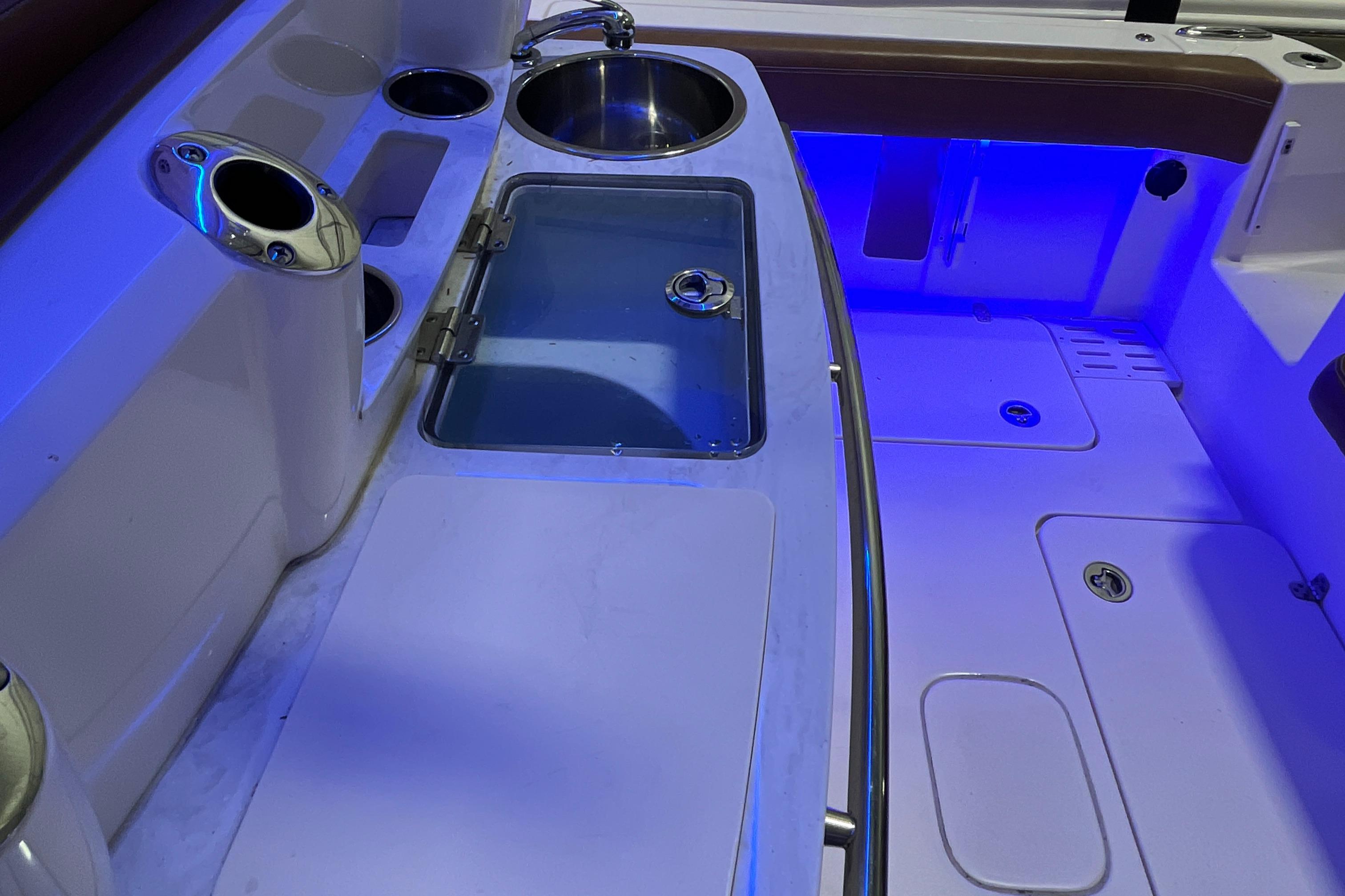 2021 Scout 305 LXF boat interior with sink and blue LED lighting.