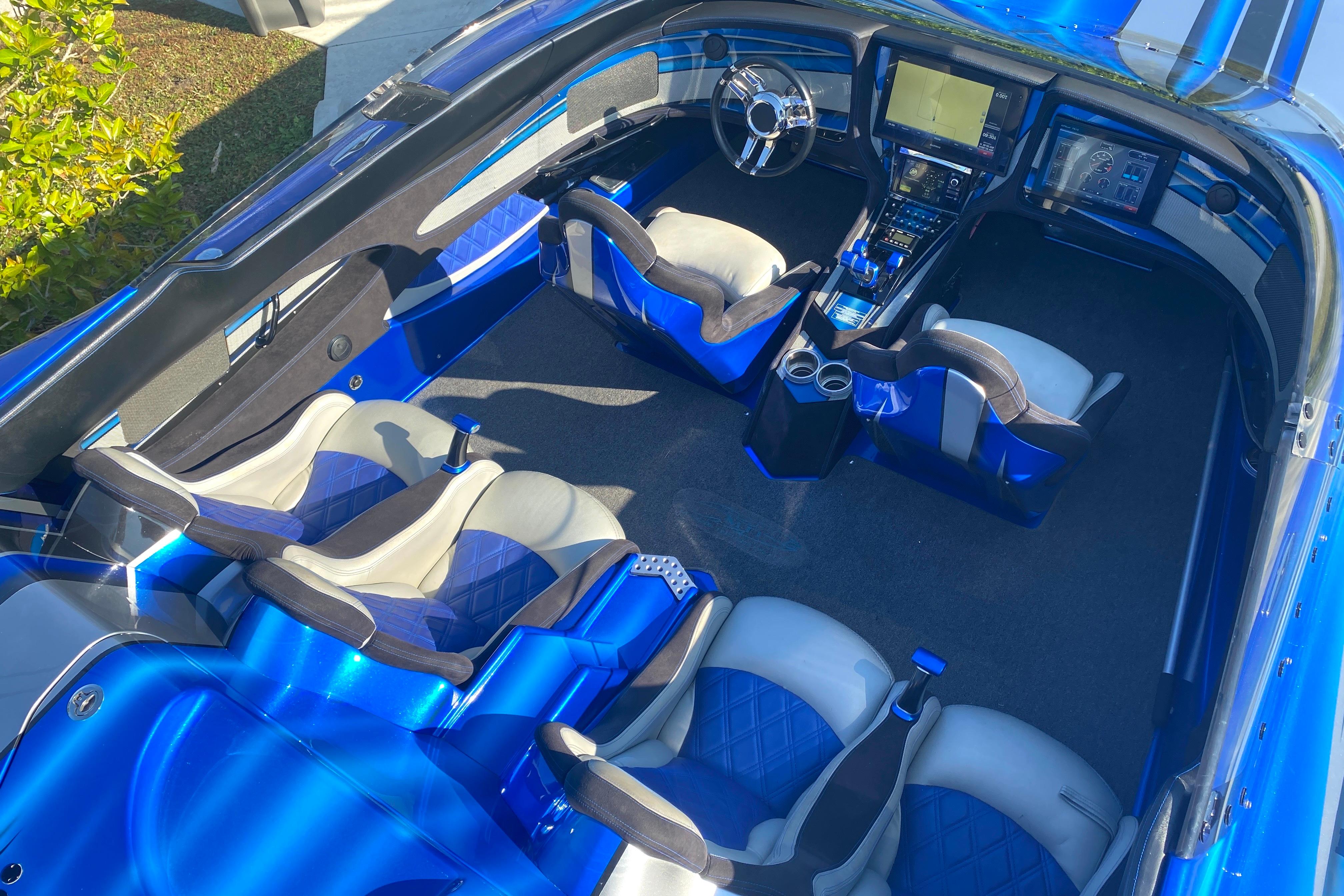 Luxurious interior of a 2016 MTI 44 RP boat with blue and white seating.