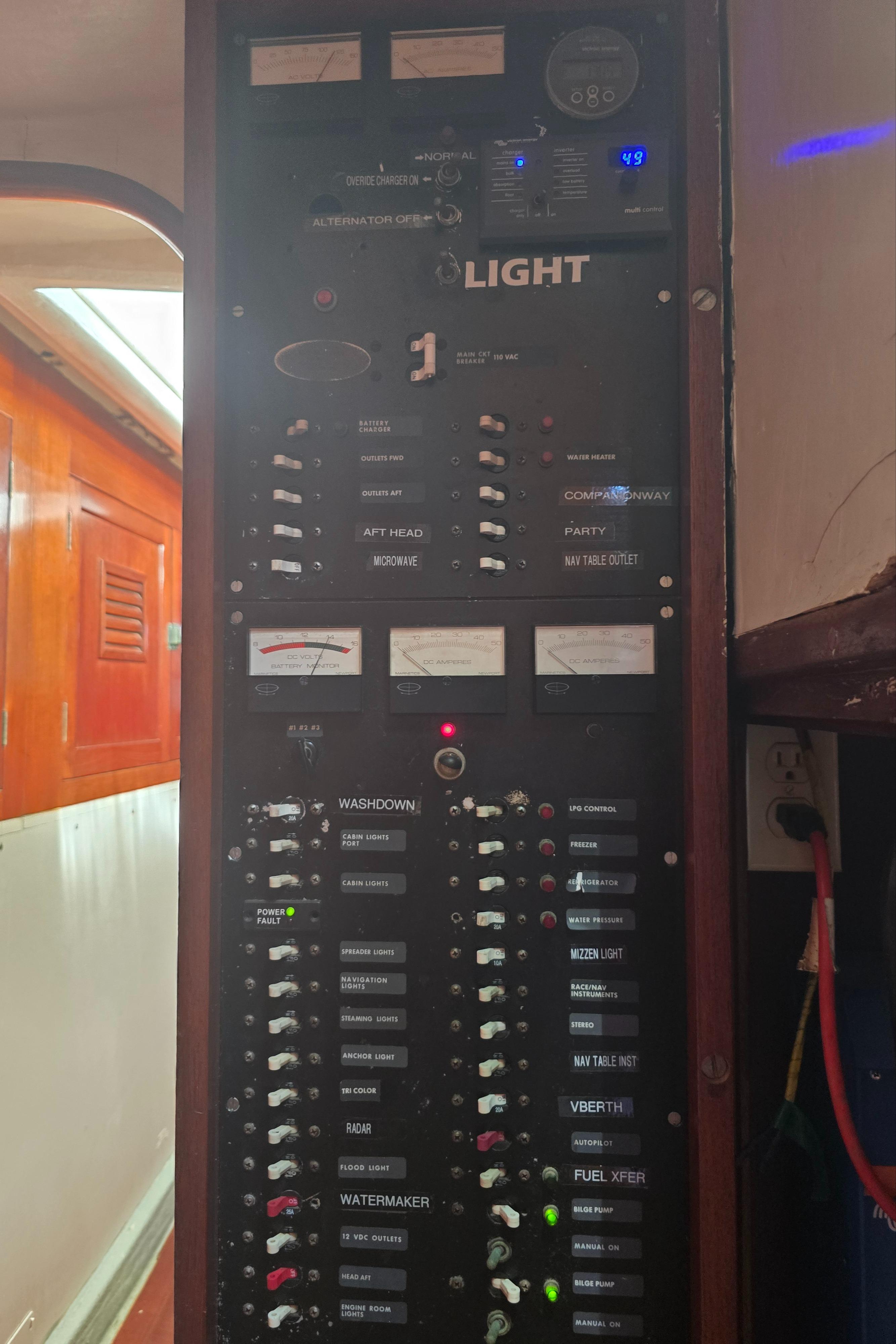 Electrical panel inside a 1978 Herreshoff 50 yacht, featuring various switches and controls.