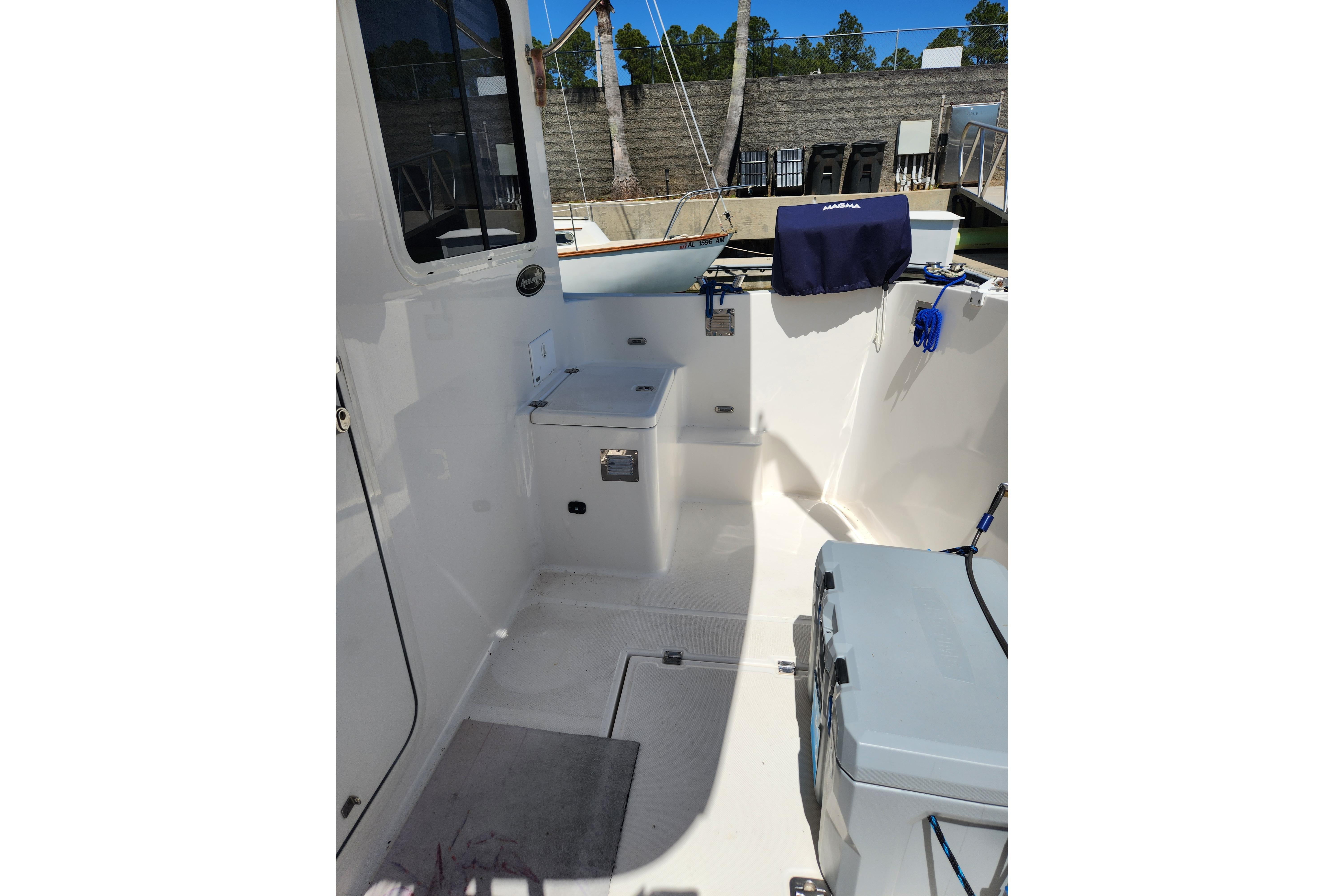 2006 American Tug AT boat deck with storage compartments and marine equipment.