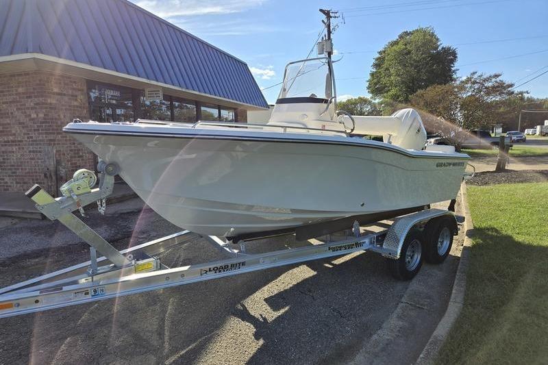 2026 Grady-White Fisherman 180 boat on trailer, parked outdoors near a building.