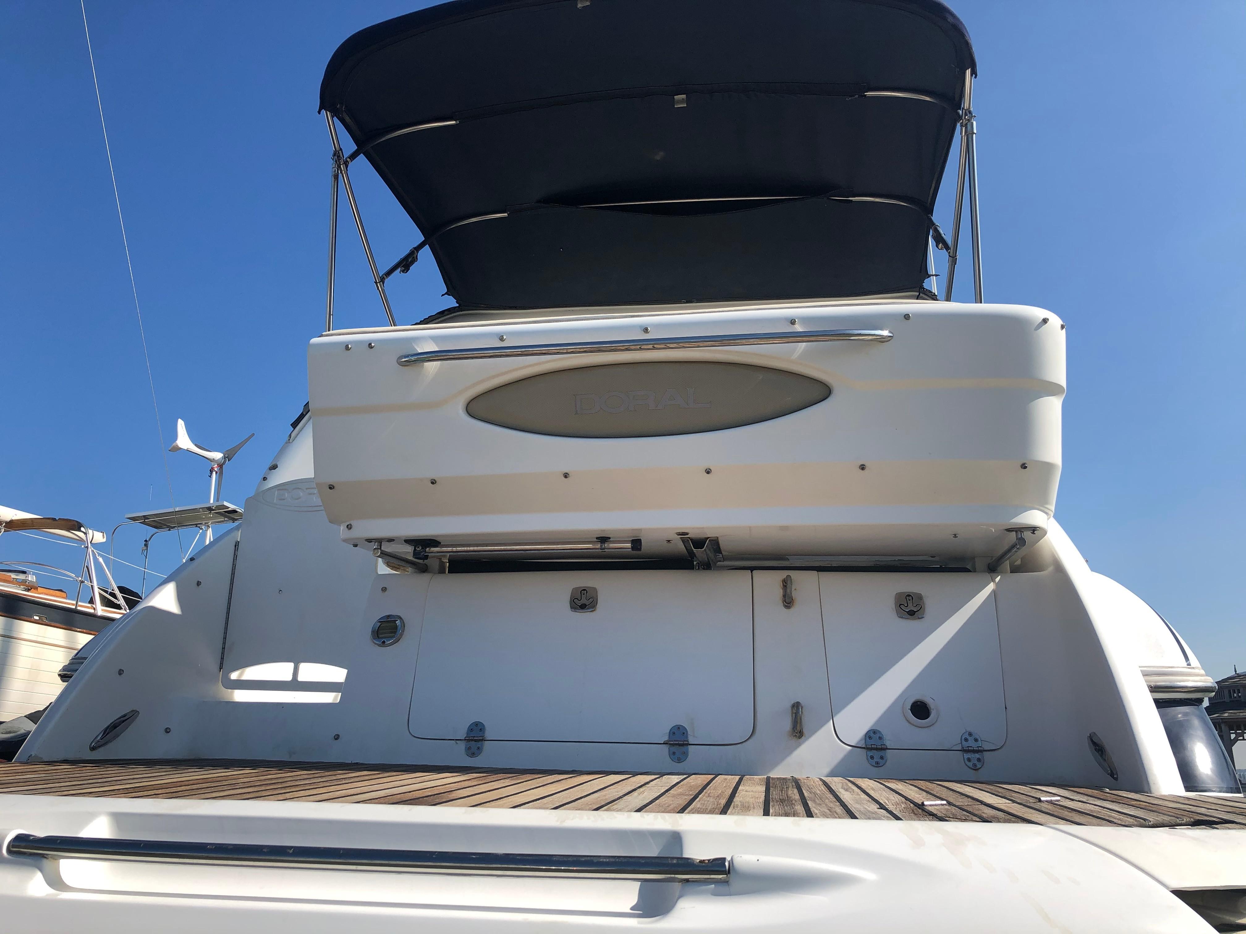 2005 Doral Monticello yacht with a sleek design and spacious deck, under clear blue sky.