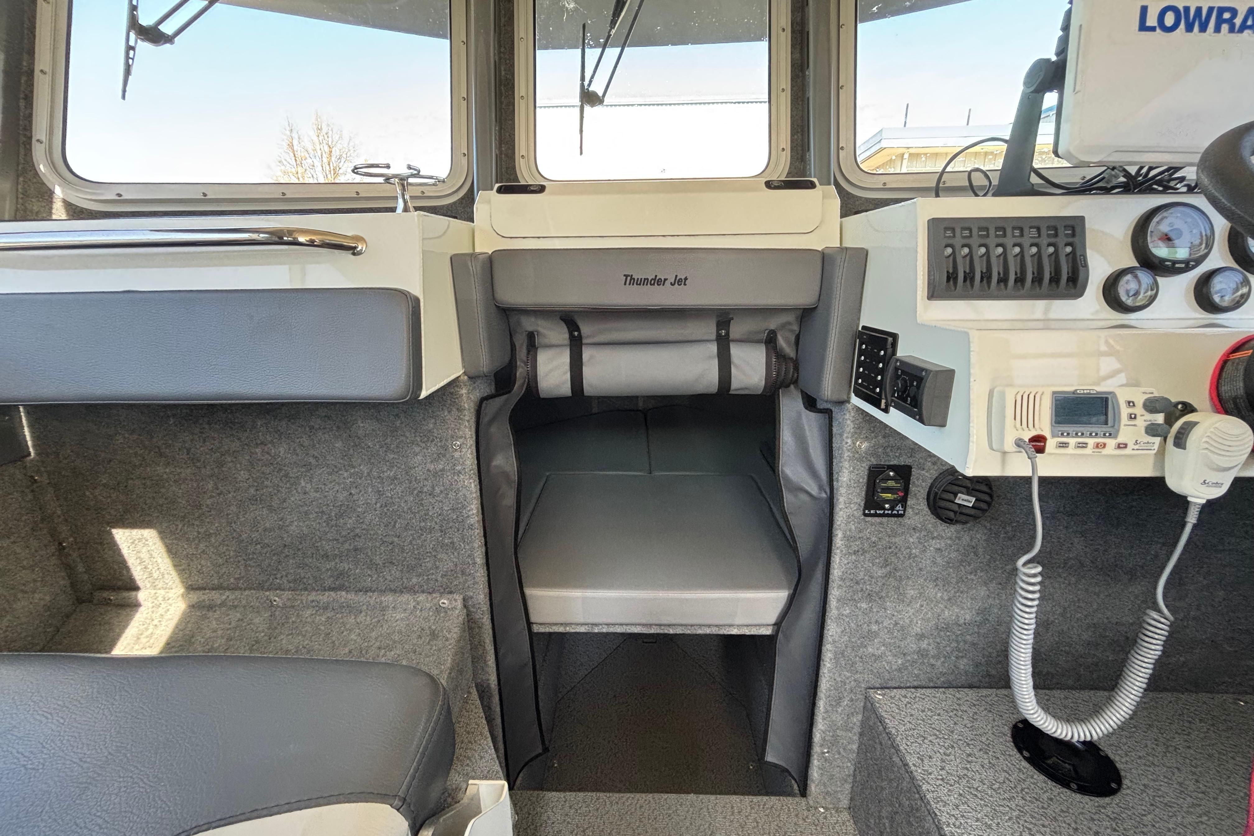 Interior of a 2021 Thunder Jet 28 Pilot boat with control panel and seating.