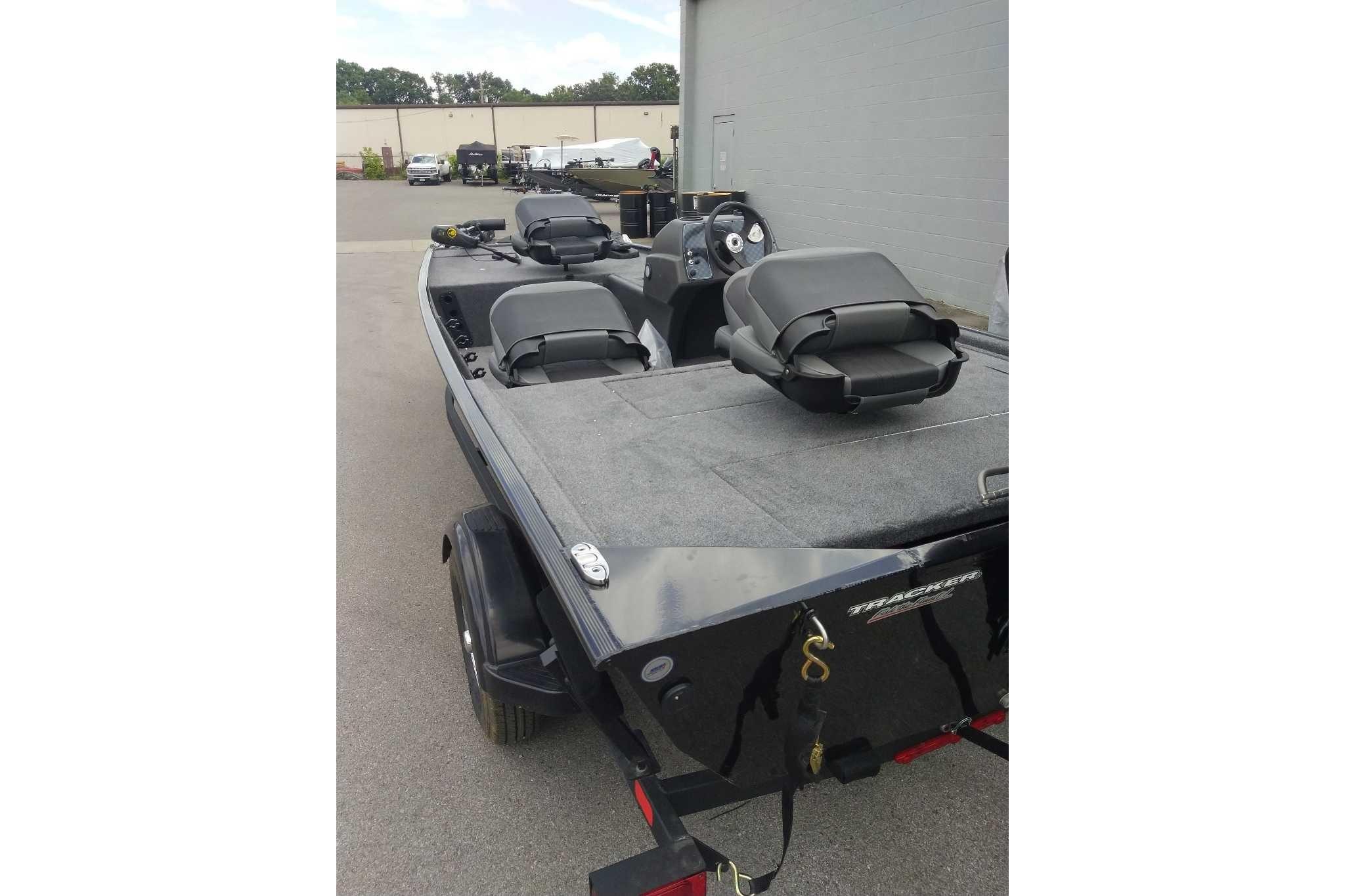 2026 Tracker Bass Tracker Classic XL boat with seating, parked outdoors.