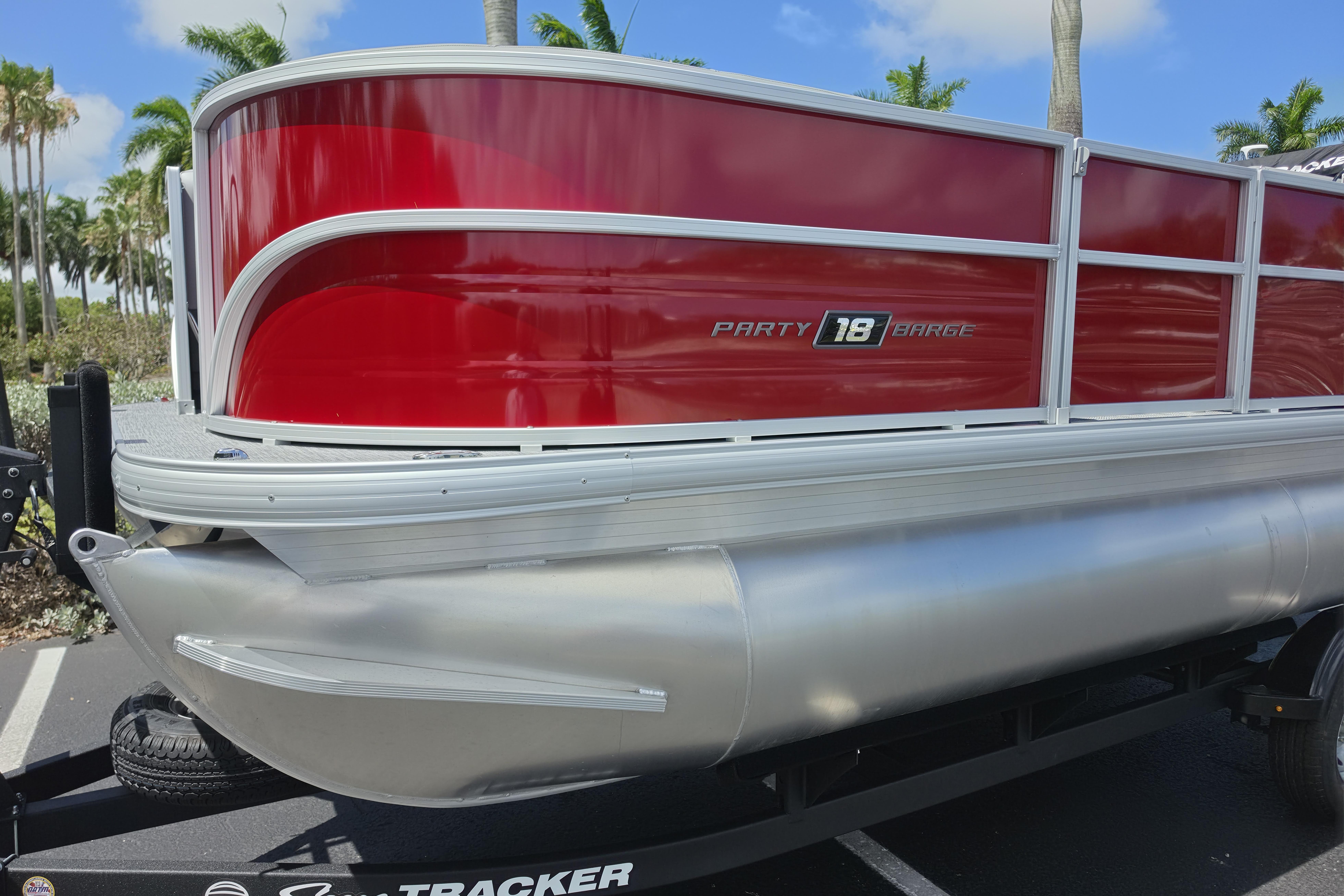 2026 Sun Tracker Party Barge 18 DLX pontoon boat with red and silver design.
