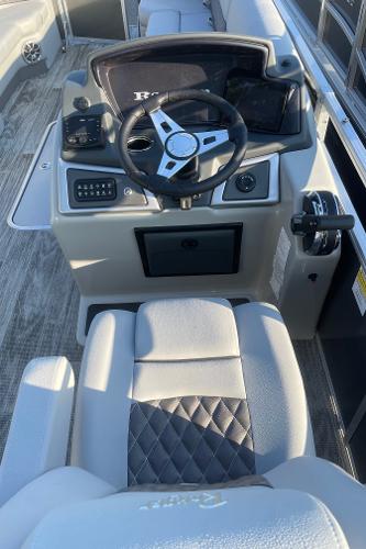 2024 Ranger Reata 223C boat interior with steering wheel and control panel.