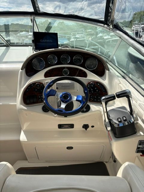 The cockpit of a 2005 Sea Ray Sundancer 280 with a modern helm station.