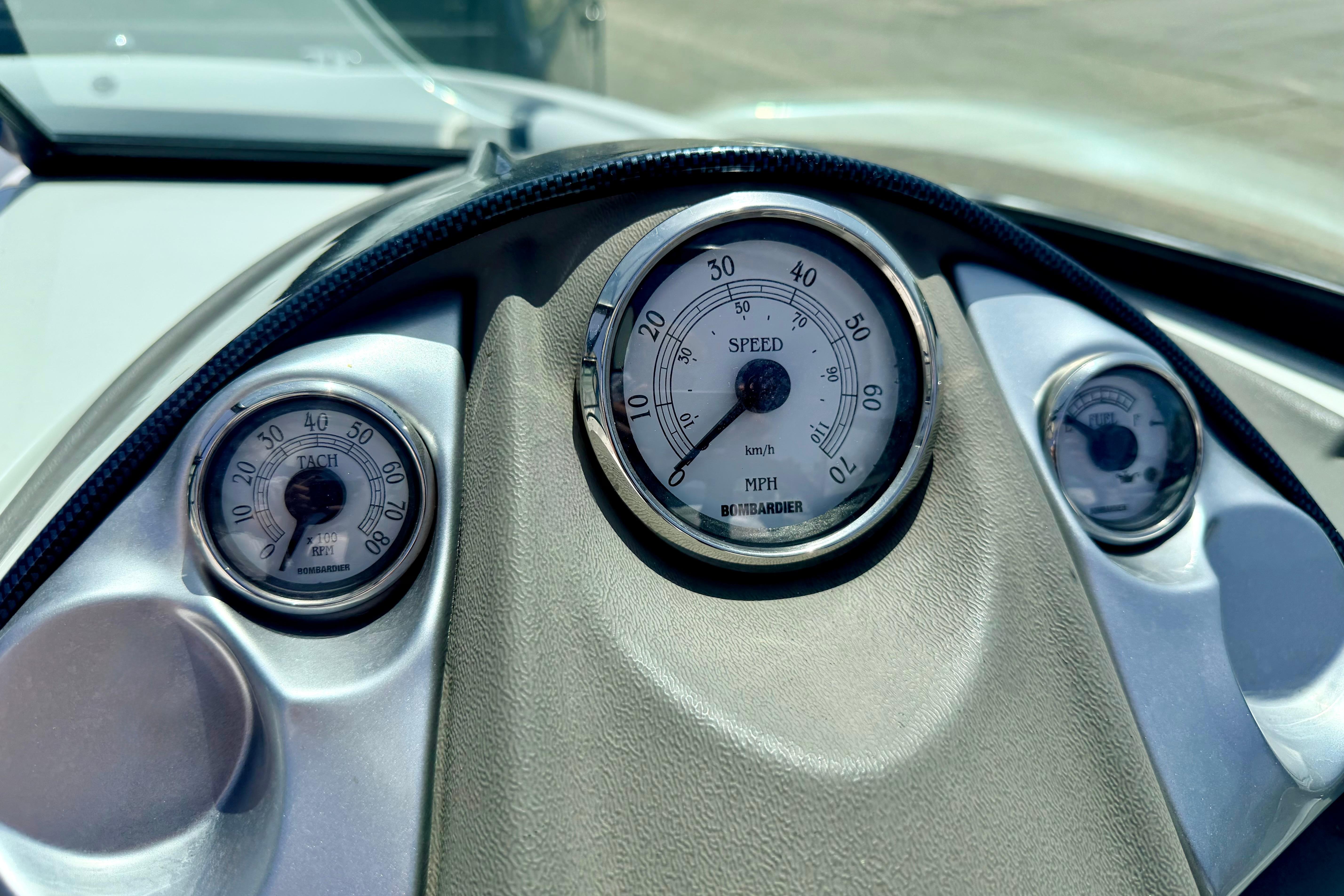 Dashboard of a 2004 Bombardier SEADOO Utopia 185, featuring speedometer and tachometer gauges.