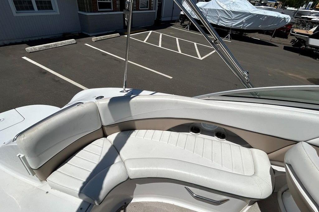 2006 Four Winns 244 Funship boat interior with white seating and cup holders.