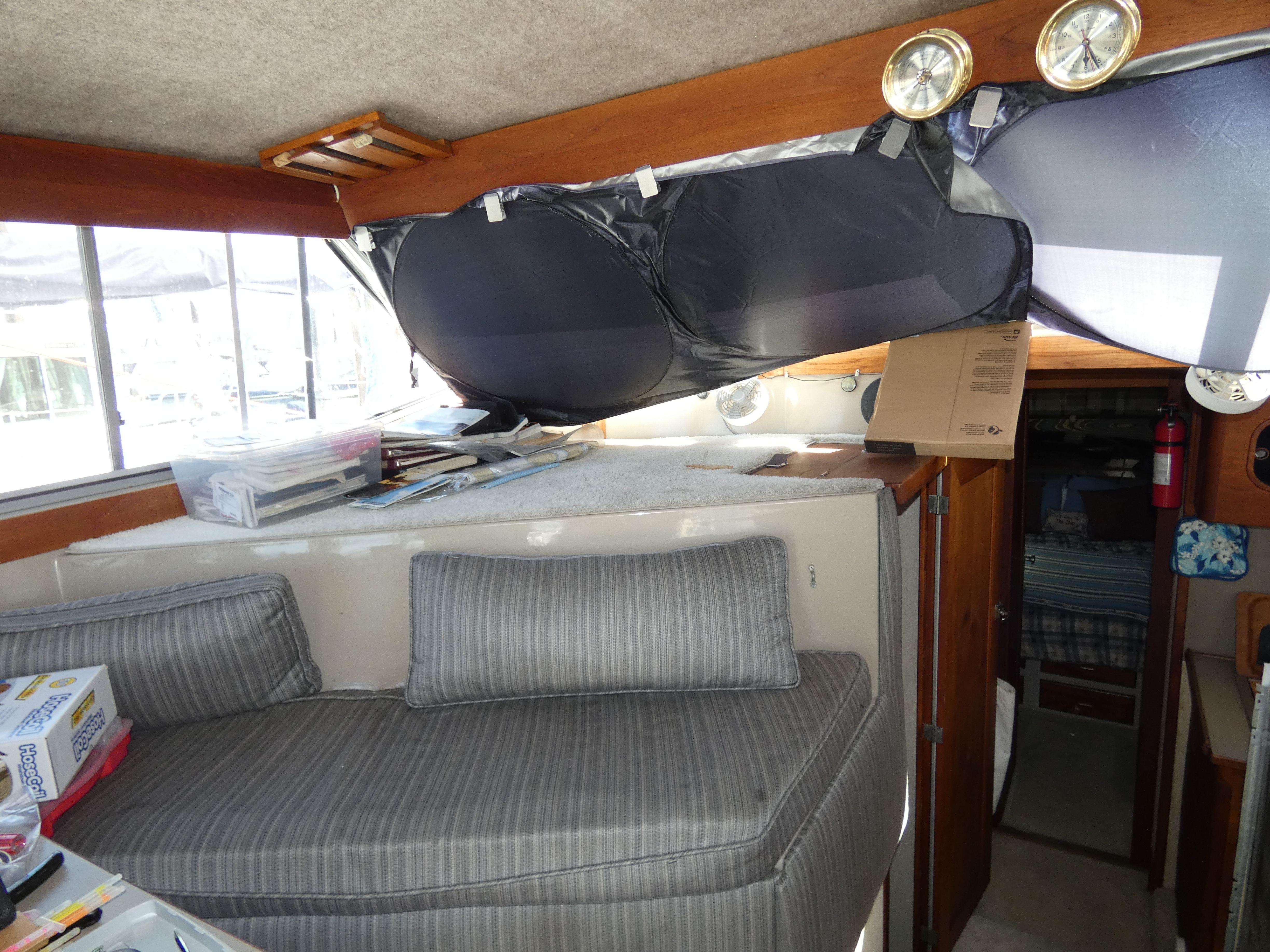 Interior of a 1984 Bayliner 3870 Motoryacht with gray cushions.
