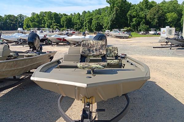 2025 Tracker Grizzly 1754 SC boat in a marina, featuring camouflage seating.