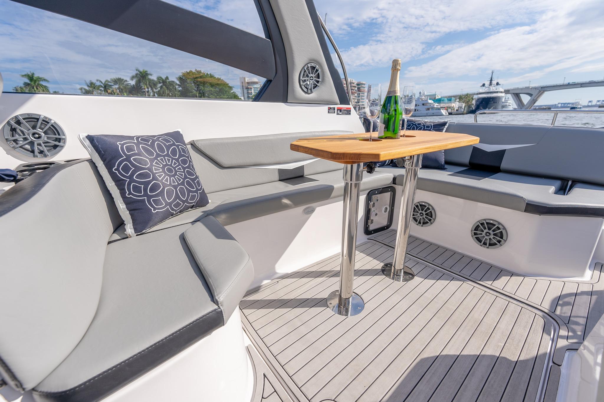 Luxurious Hanover 305 yacht interior with seating, table, and champagne, 2027 model.