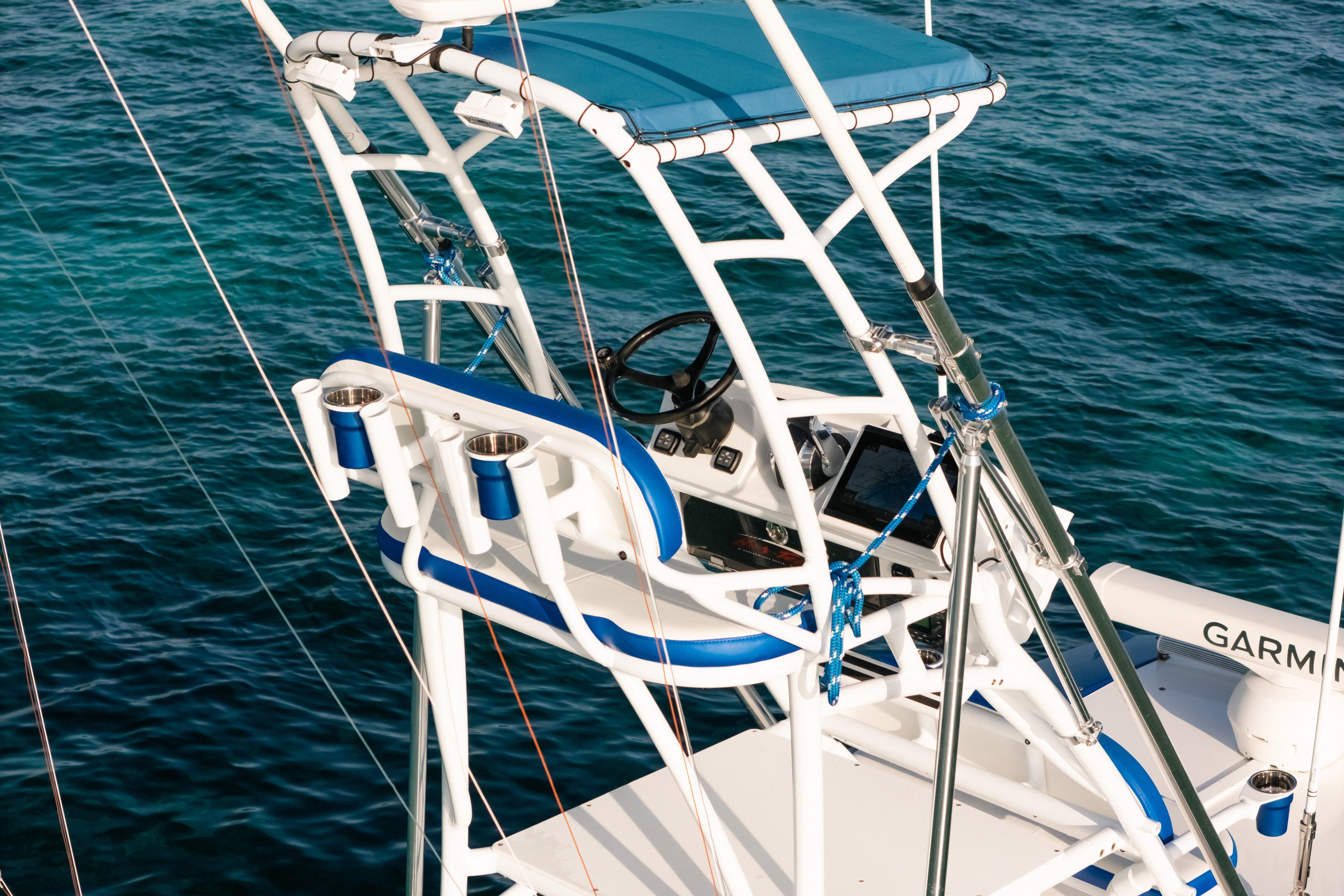 2022 Nor-Tech 392 Super Fish boat helm with blue accents on clear water.