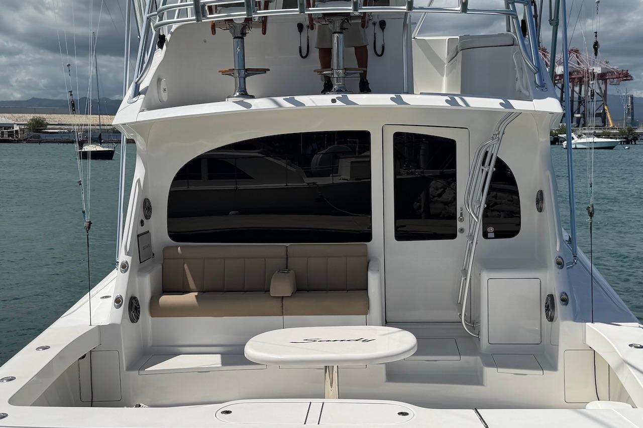 2012 Viking 50 Convertible yacht with spacious deck and seating area, docked at marina.