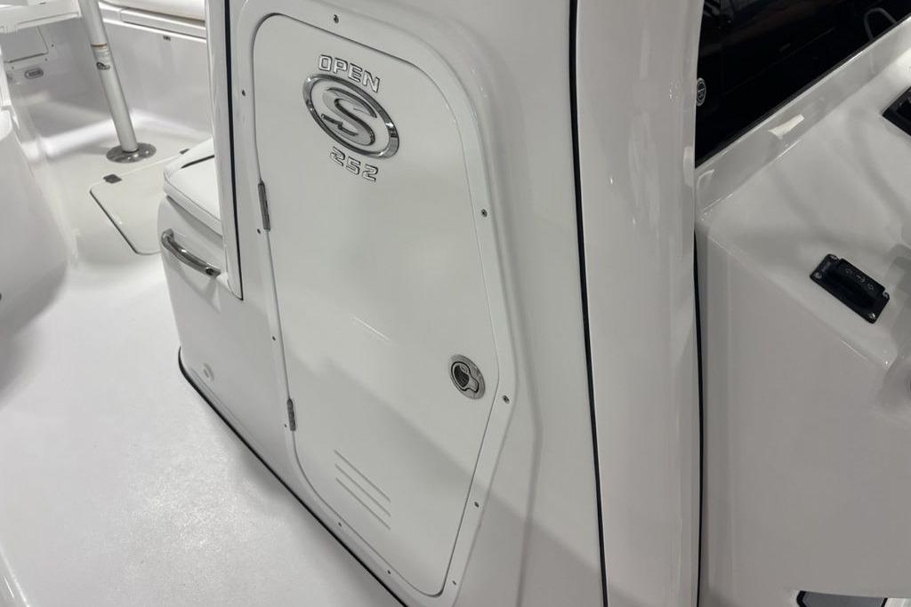 2026 Sportsman Open 252 Center Console boat interior, featuring sleek white design and storage compartment.