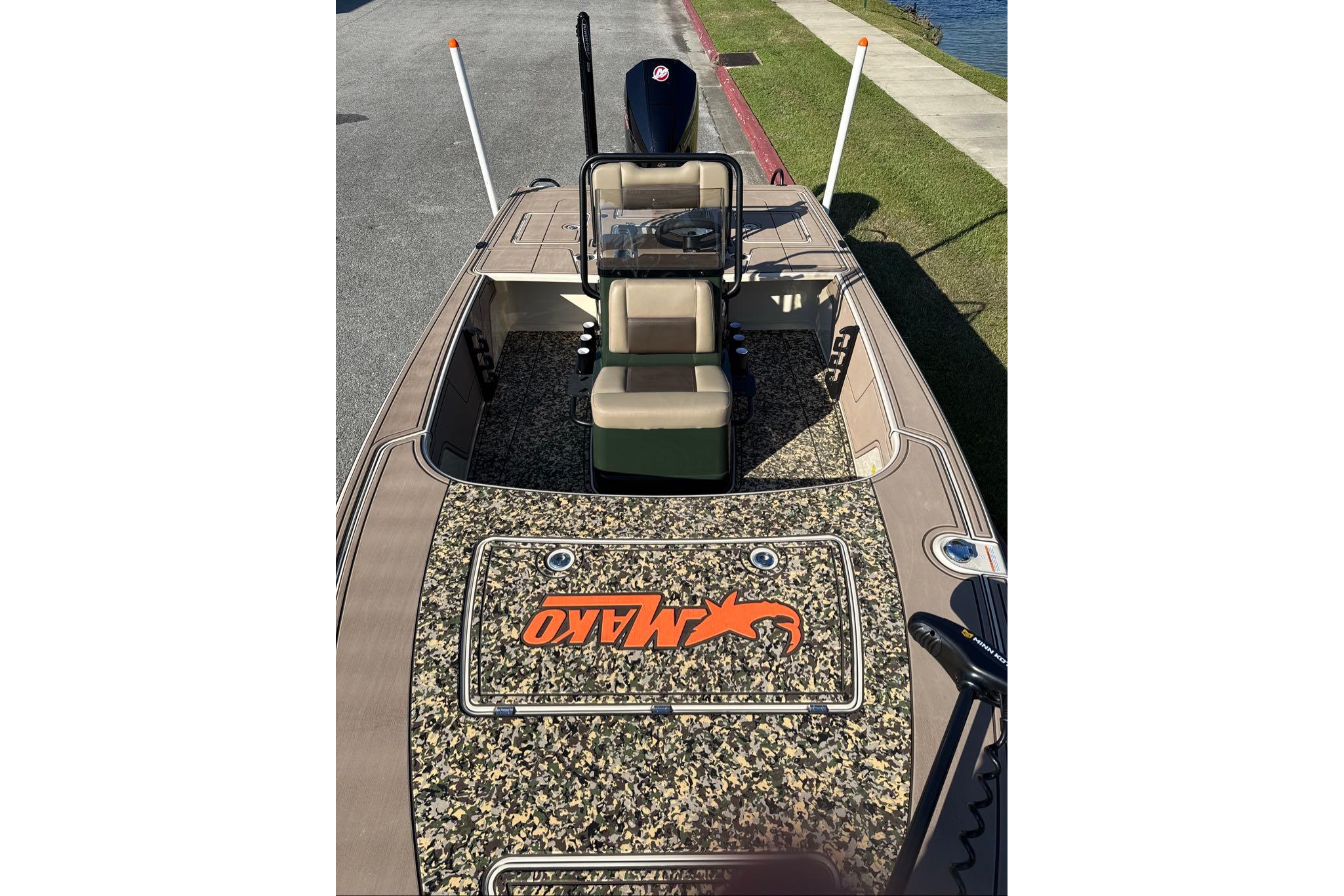 2026 Mako 18 Pro Skiff Backwater Edition boat with camo deck and seating.