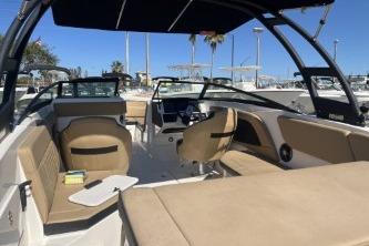 2024 Sea Ray SPX 230 boat interior with beige seating and modern dashboard.