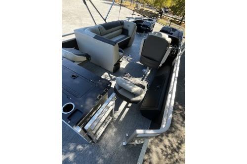 2026 Sun Tracker Fishin' Barge 22 DLX interior with seating and fishing amenities.