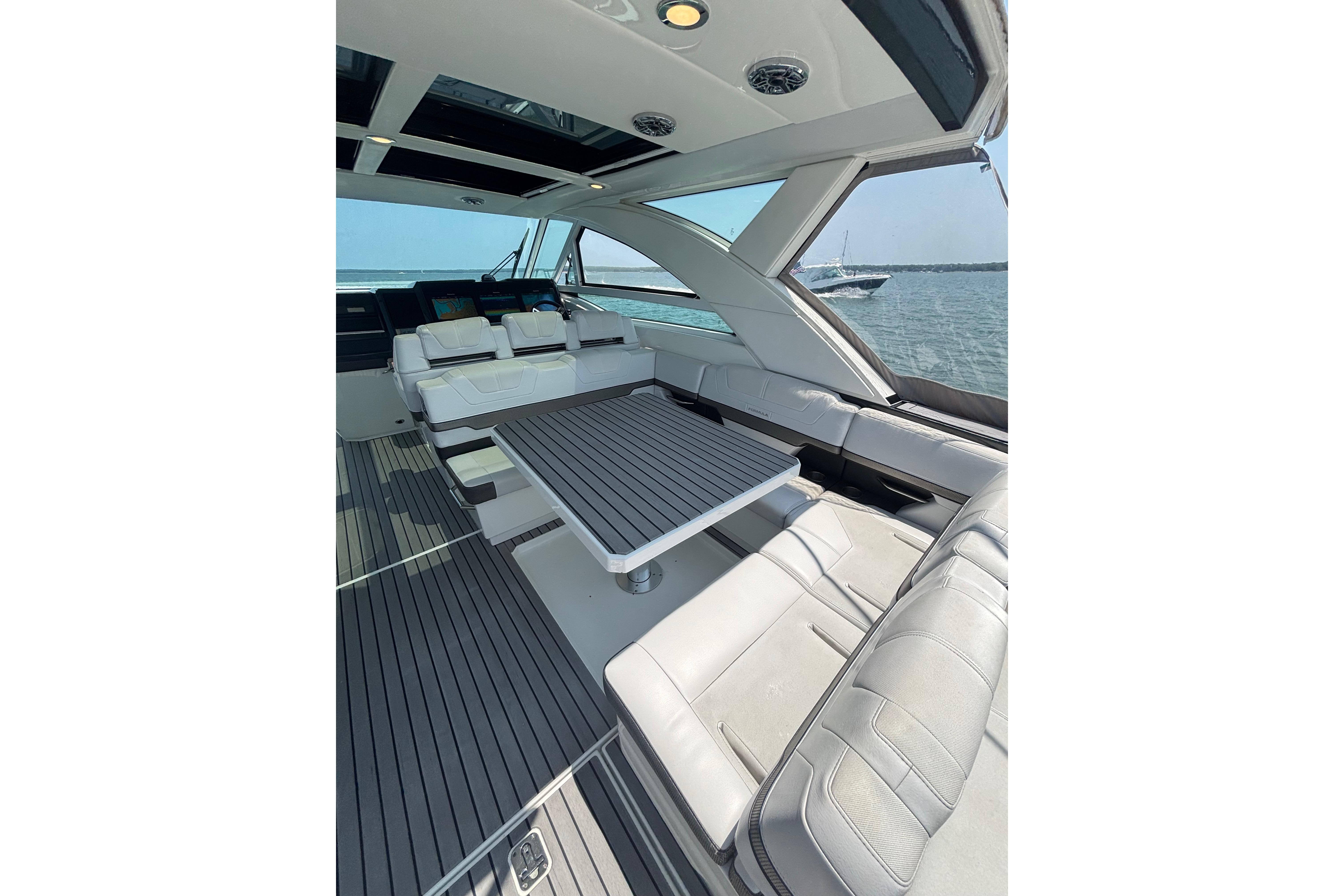 Luxurious interior of 2019 Formula 430 Super Sport Crossover yacht with sleek seating and table.