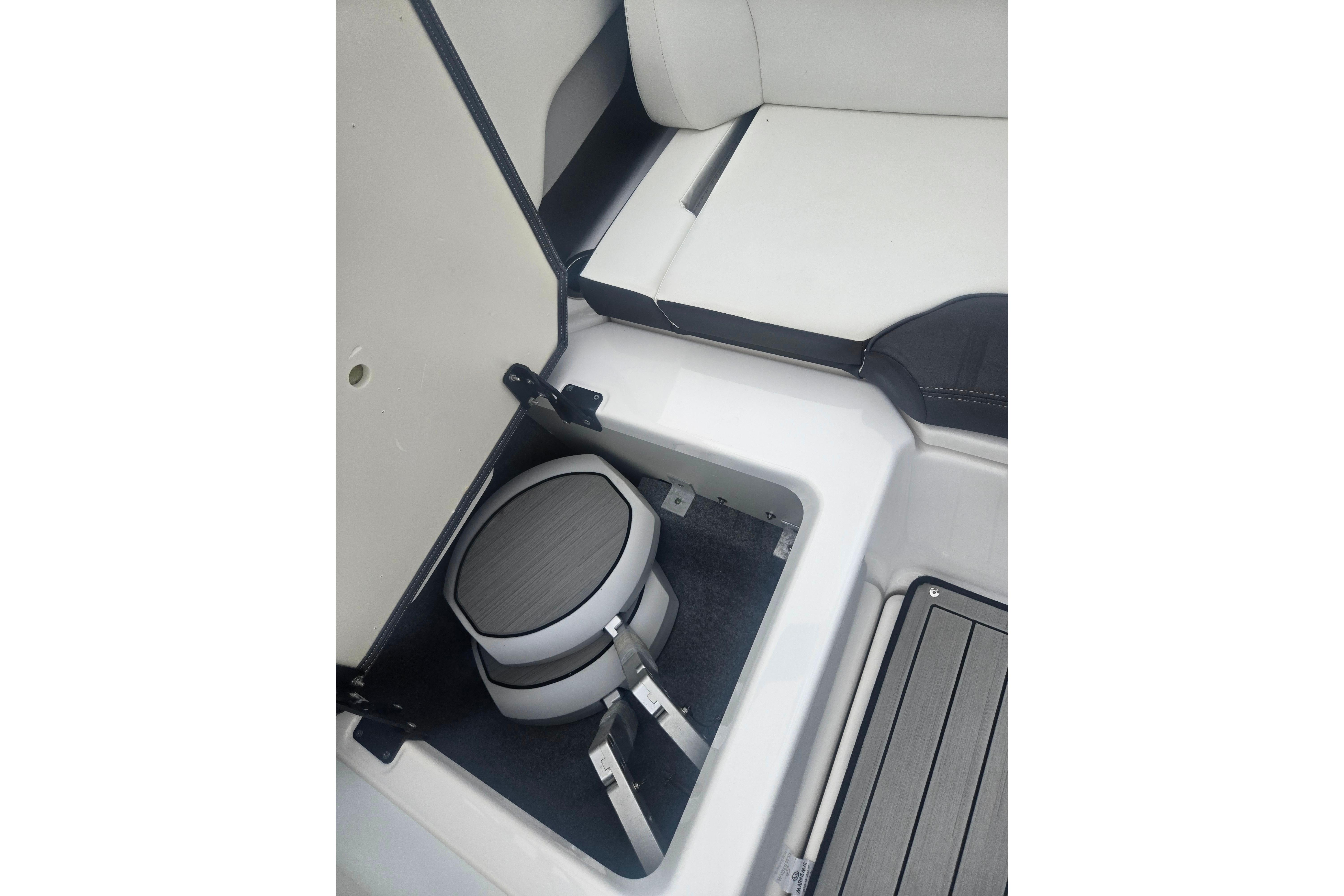 2023 Yamaha Boats 252S storage compartment with sleek seating and modern design.