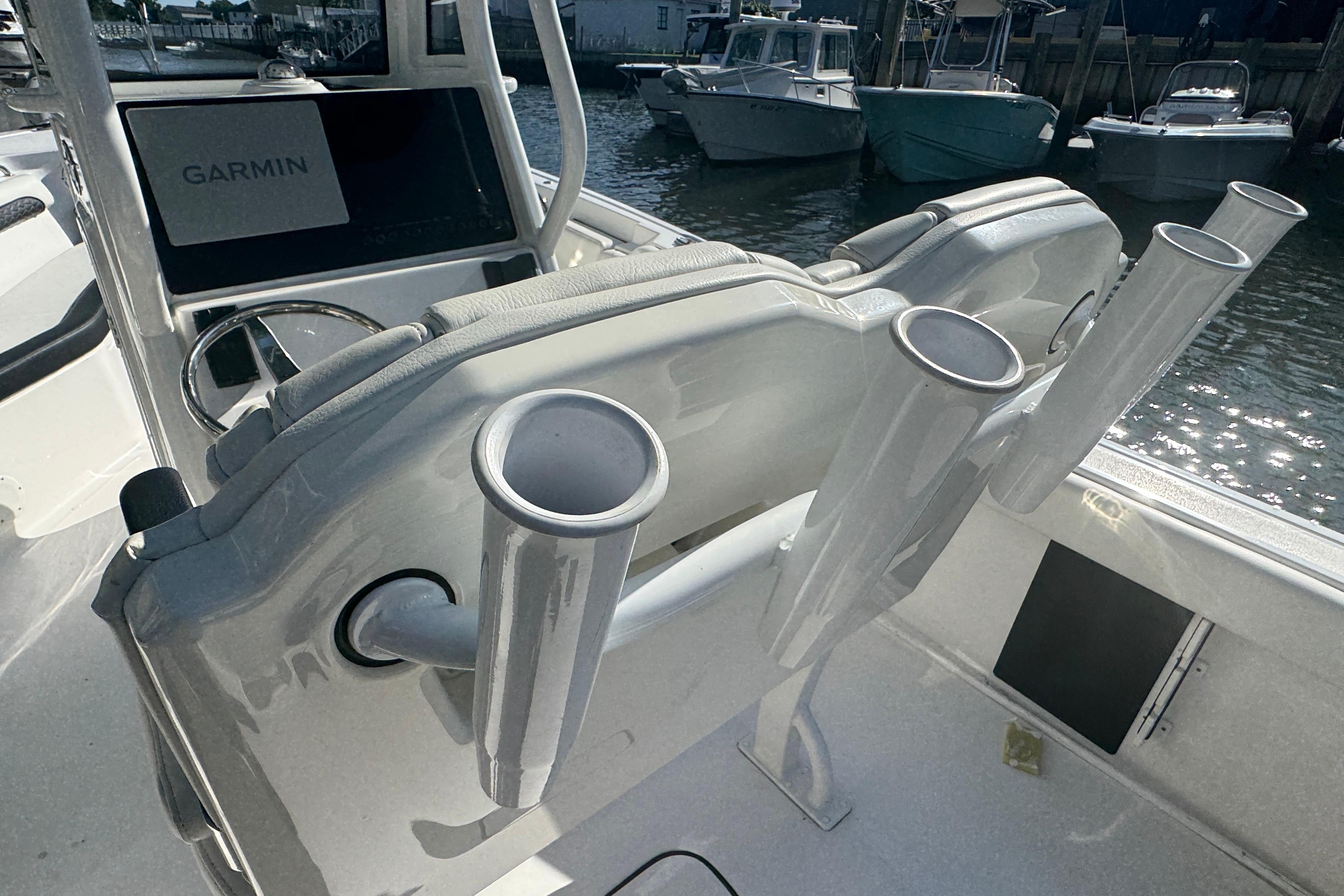 2025 Tidewater 232 LXF boat interior with Garmin display and rod holders.