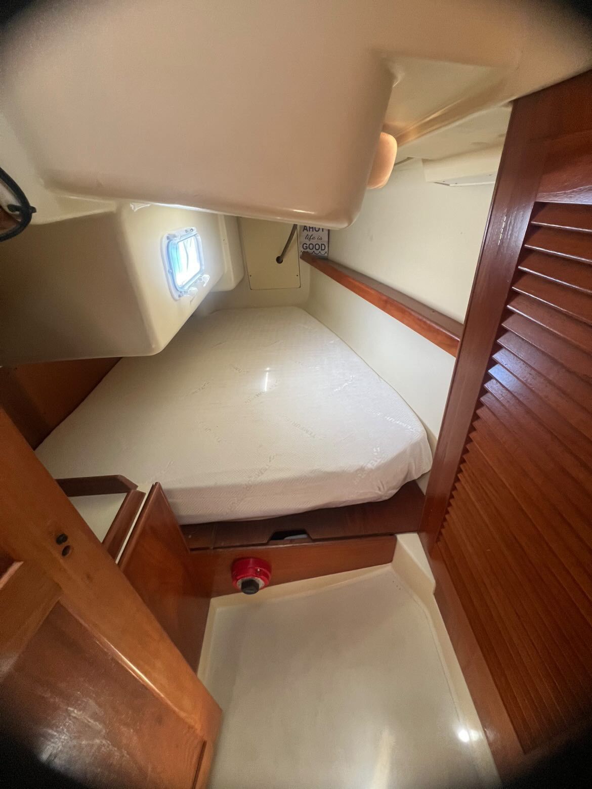 Interior of a 1988 Pearson 28 with a sleeping berth and wooden doors.