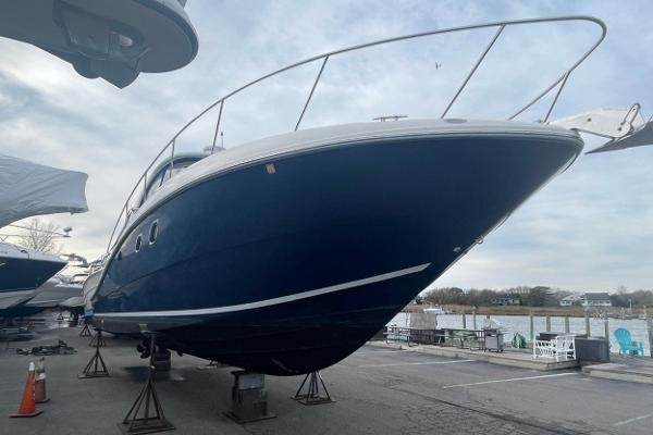 2008 Sea Ray 330 Sundancer yacht on stands, marina background, overcast sky.